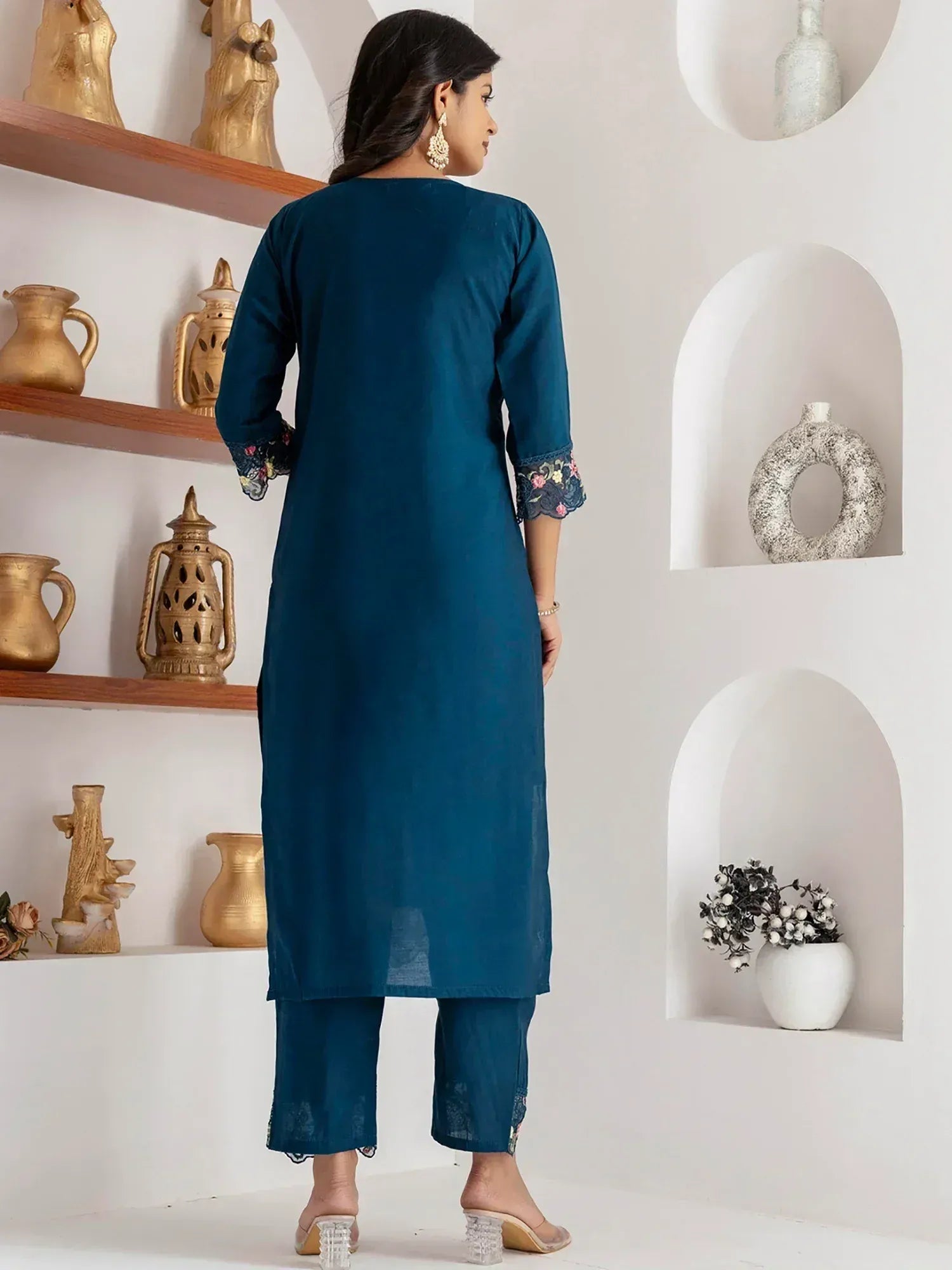 Teal blue ethnic kurta with floral embroidery on sleeves and pants, styled for Indian wear
