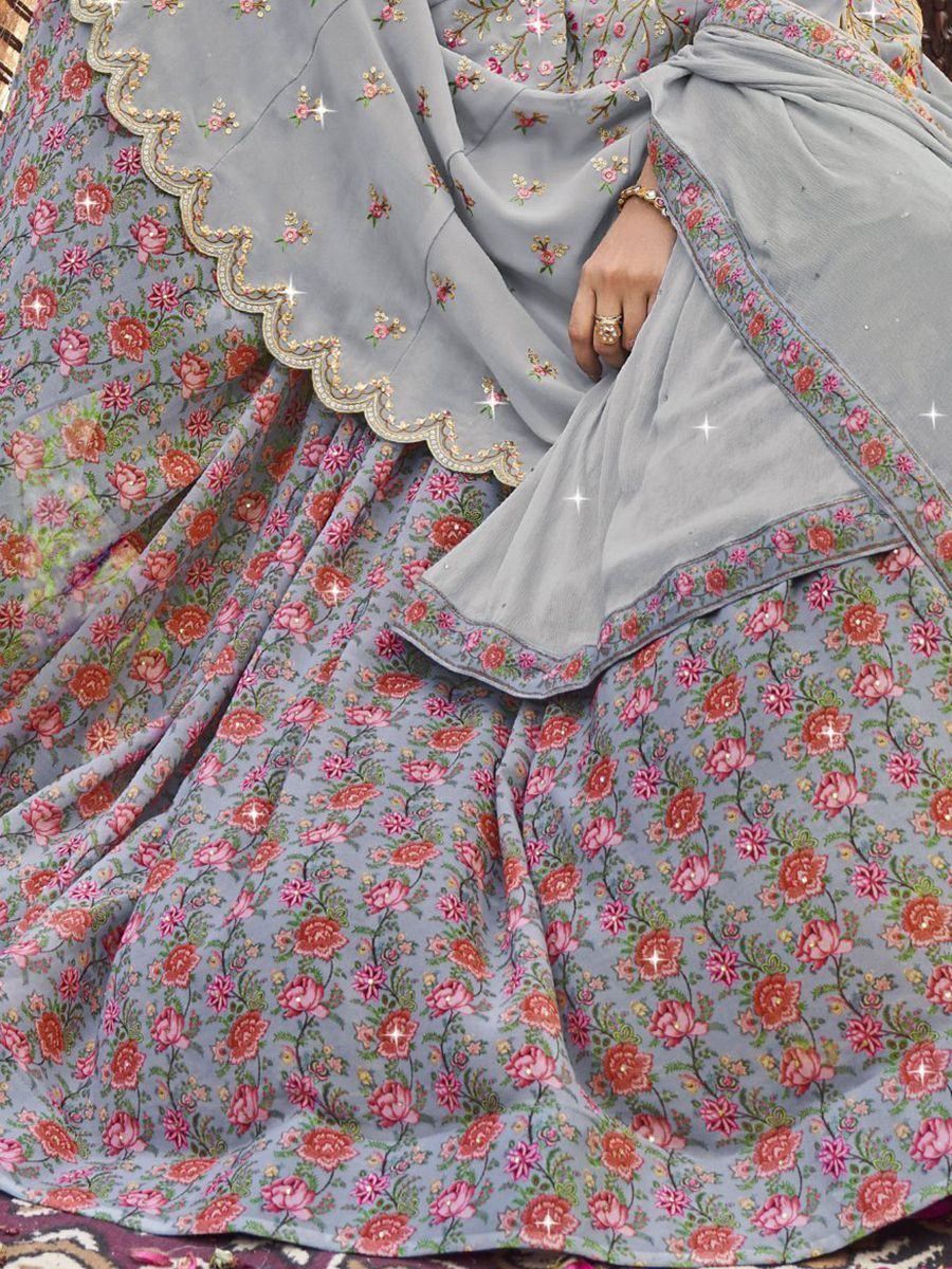 Woman in a light blue floral embroidered lehenga choli with matching dupatta