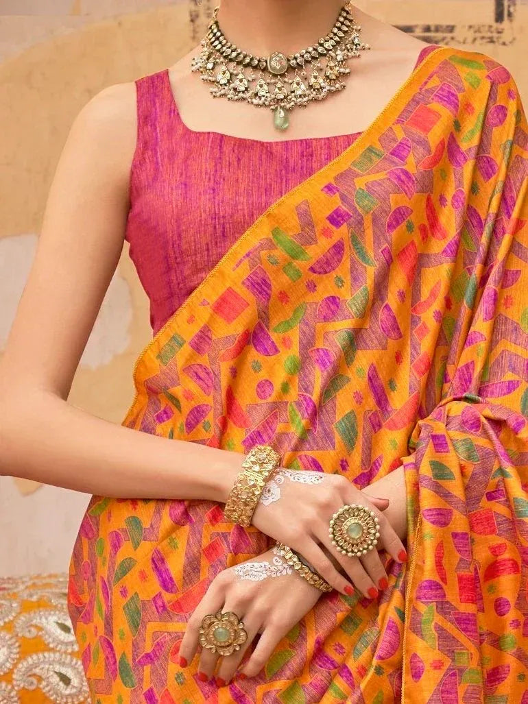 Vibrant orange printed saree with pink blouse, traditional jewelry, and henna designs for Indian ethnic wear