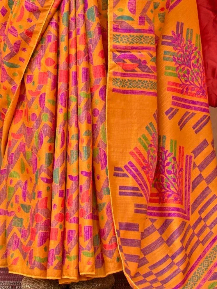 Vibrant orange ethnic saree with bold geometric and floral prints in pink, purple, green