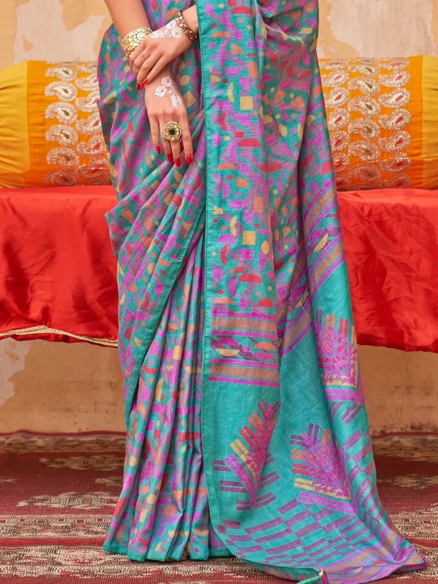 Vibrant turquoise and pink printed saree with geometric patterns, perfect for ethnic wear occasions.