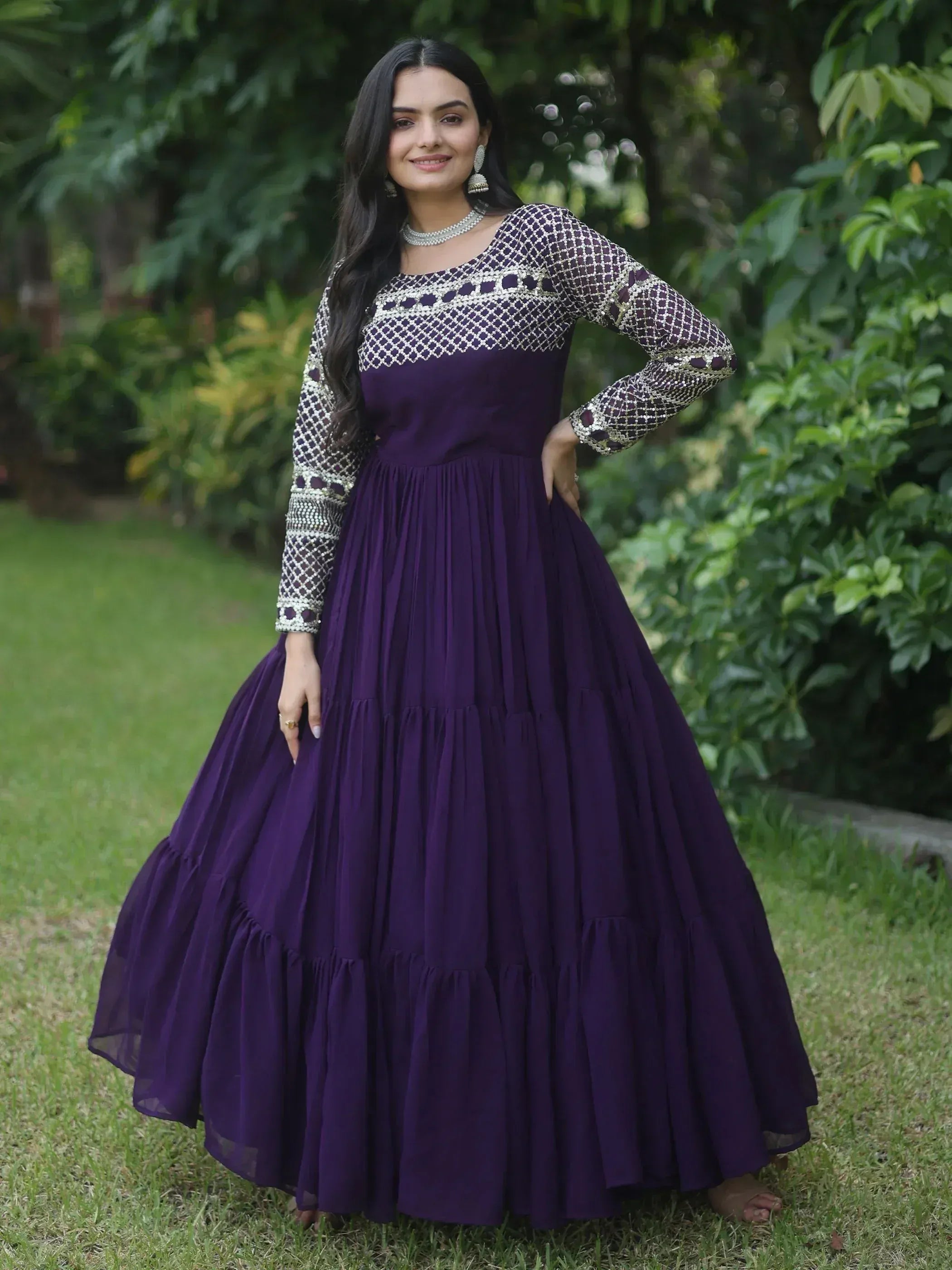 Purple ethnic gown with embroidered net sleeves and tiered skirt, perfect for Indian occasions