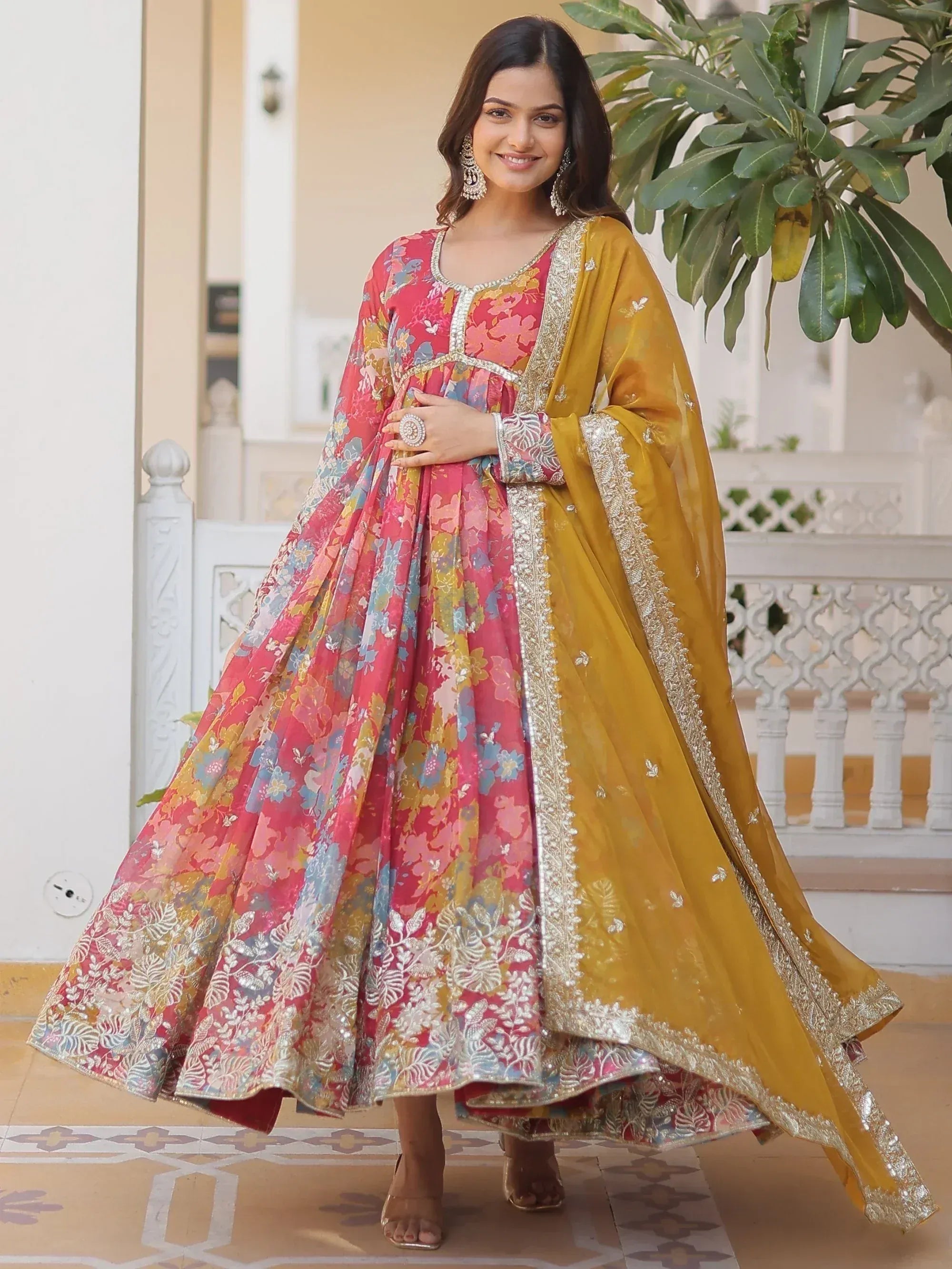 Woman in vibrant floral anarkali with gold dupatta, perfect for Indian ethnic occasions