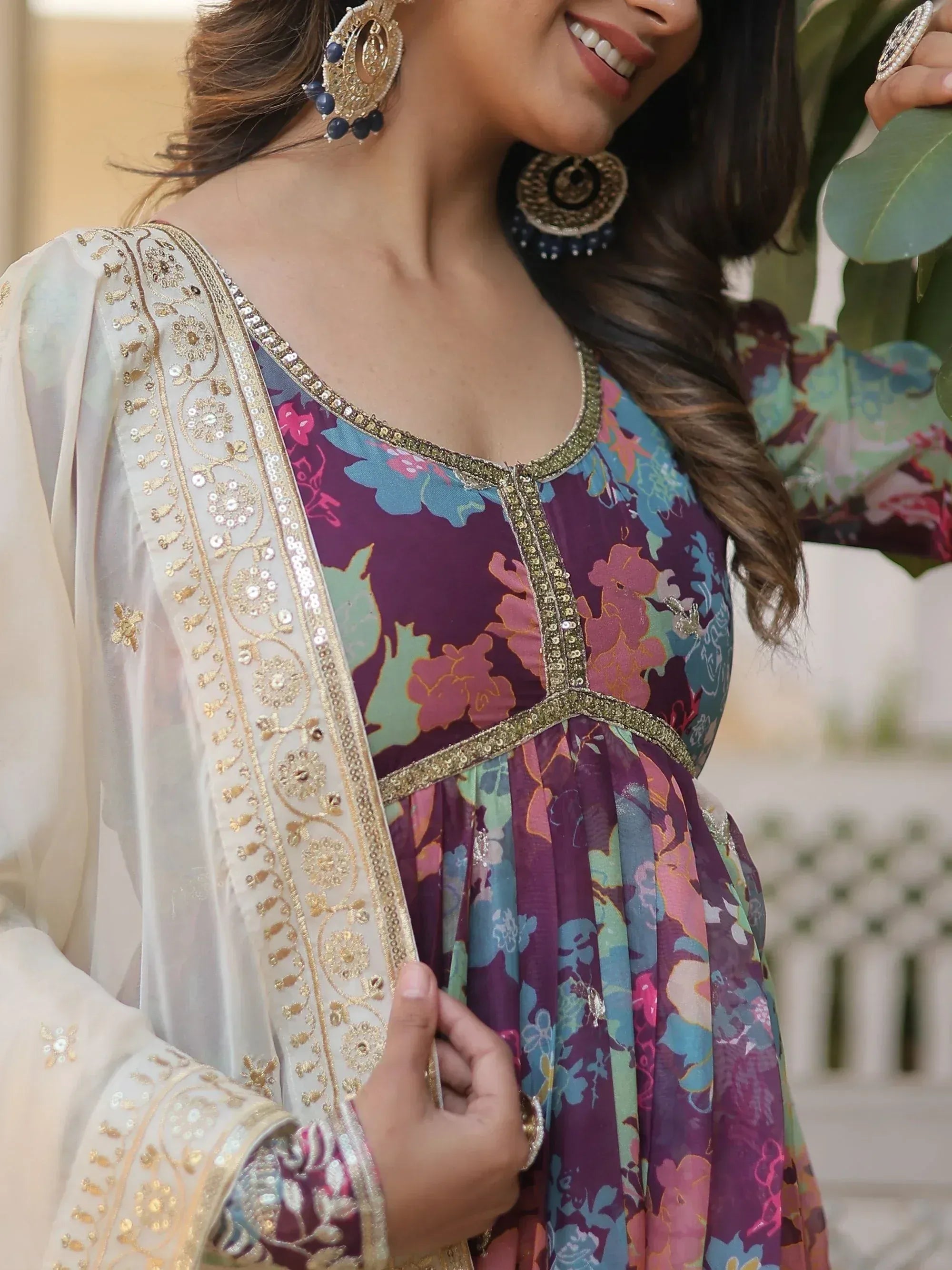 Floral printed ethnic gown with gold embroidery and matching dupatta, styled with statement earrings