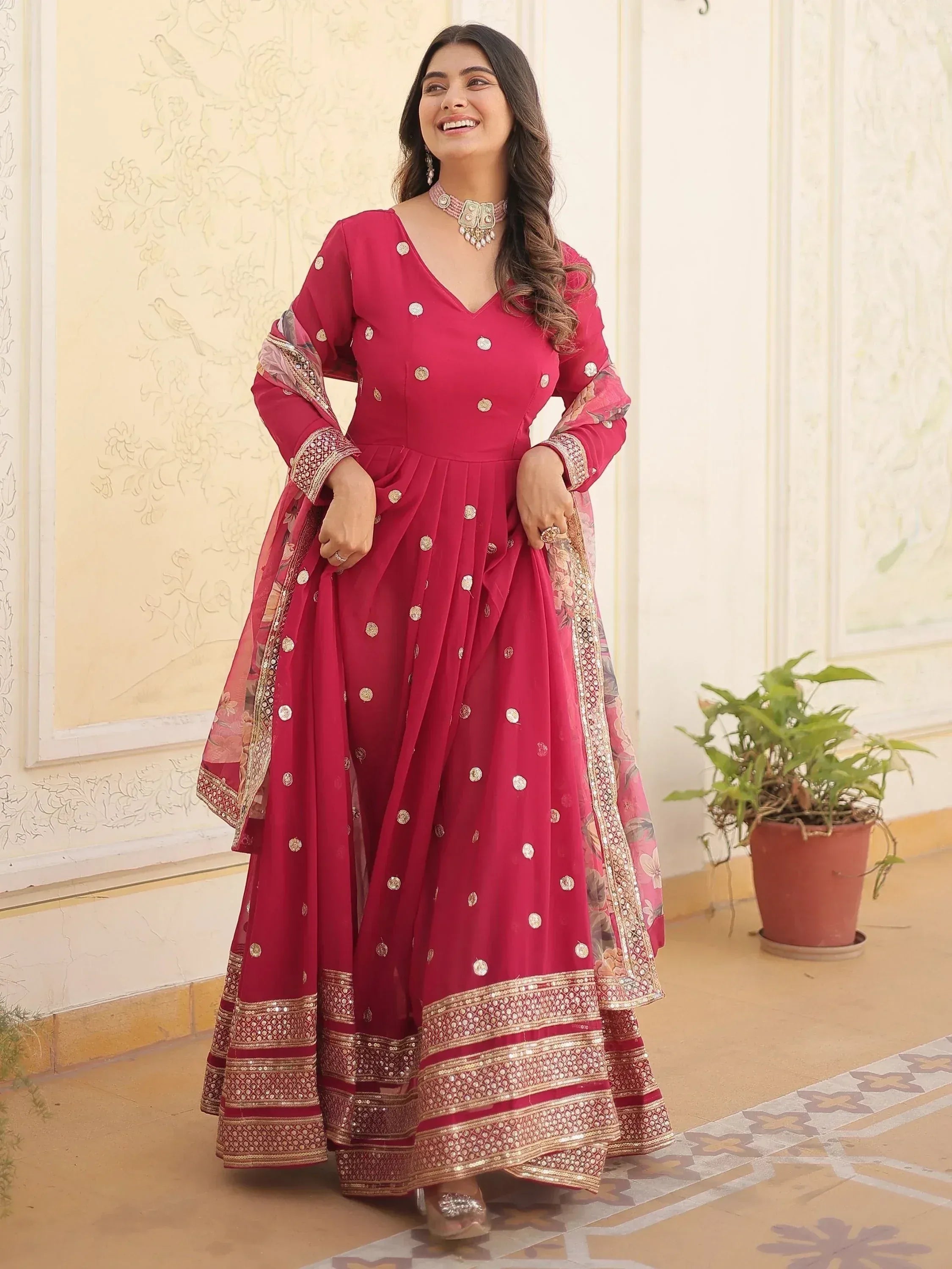 Elegant maroon ethnic anarkali suit with gold embroidery and floral dupatta, perfect for Indian occasions