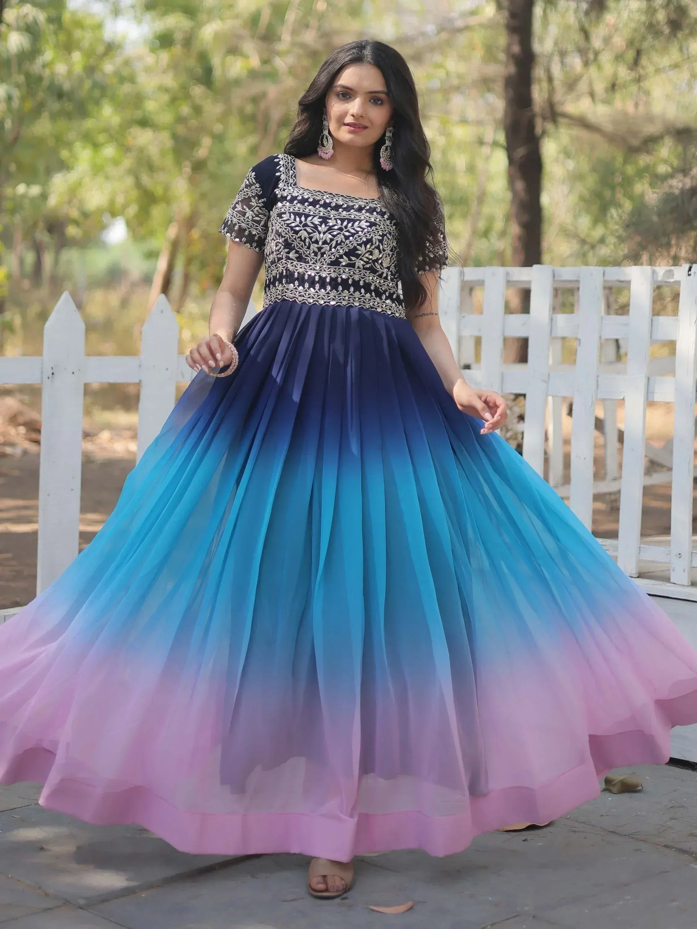 Woman in navy blue embroidered top with ombre blue to pink tulle skirt, Indian ethnic gown