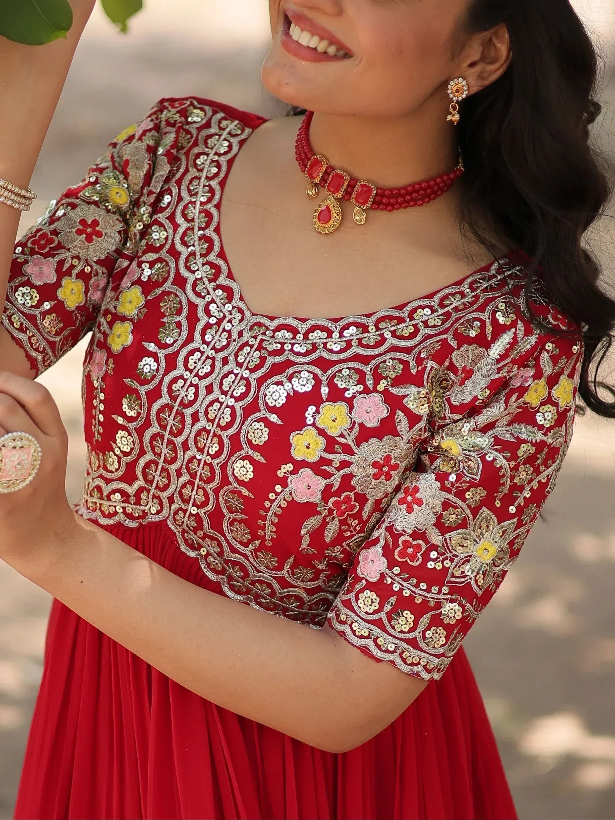 Red floral embroidered ethnic gown with gold detailing, perfect for Indian occasions and festive wear.