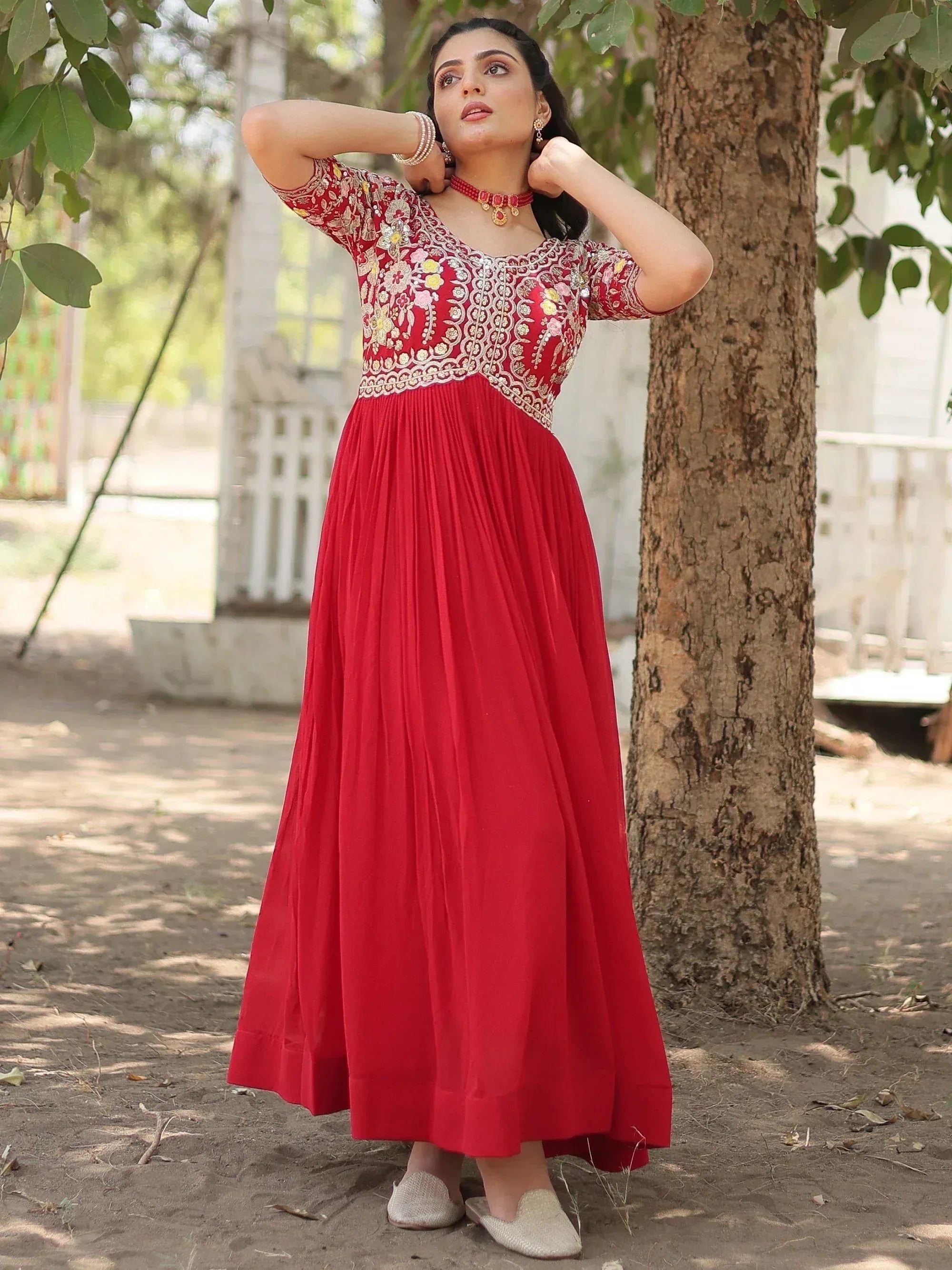Red embroidered ethnic gown with floral detailing, perfect for Indian occasions and festive wear.