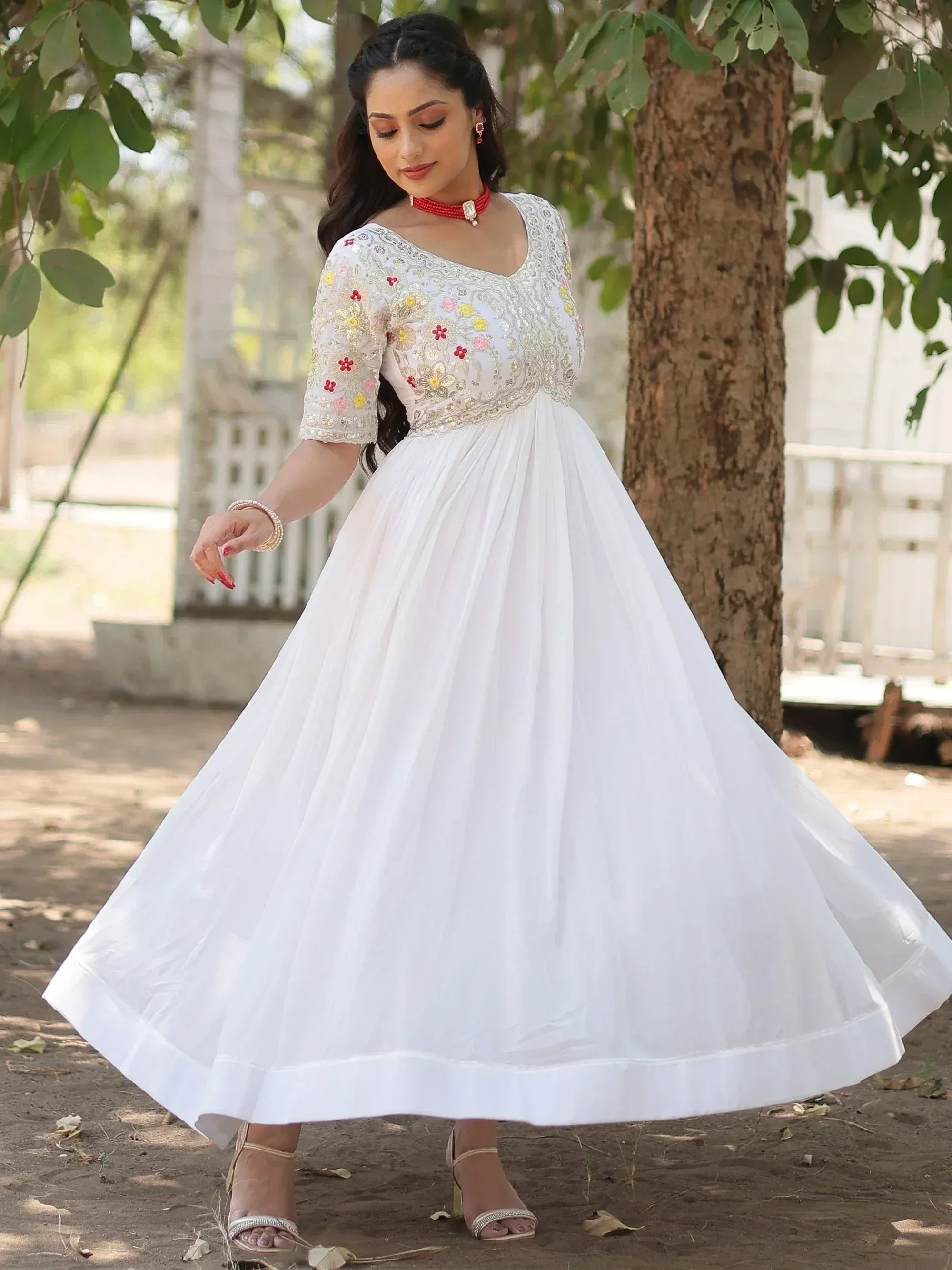 White ethnic gown with floral embroidery, perfect for Indian occasions and festive wear.