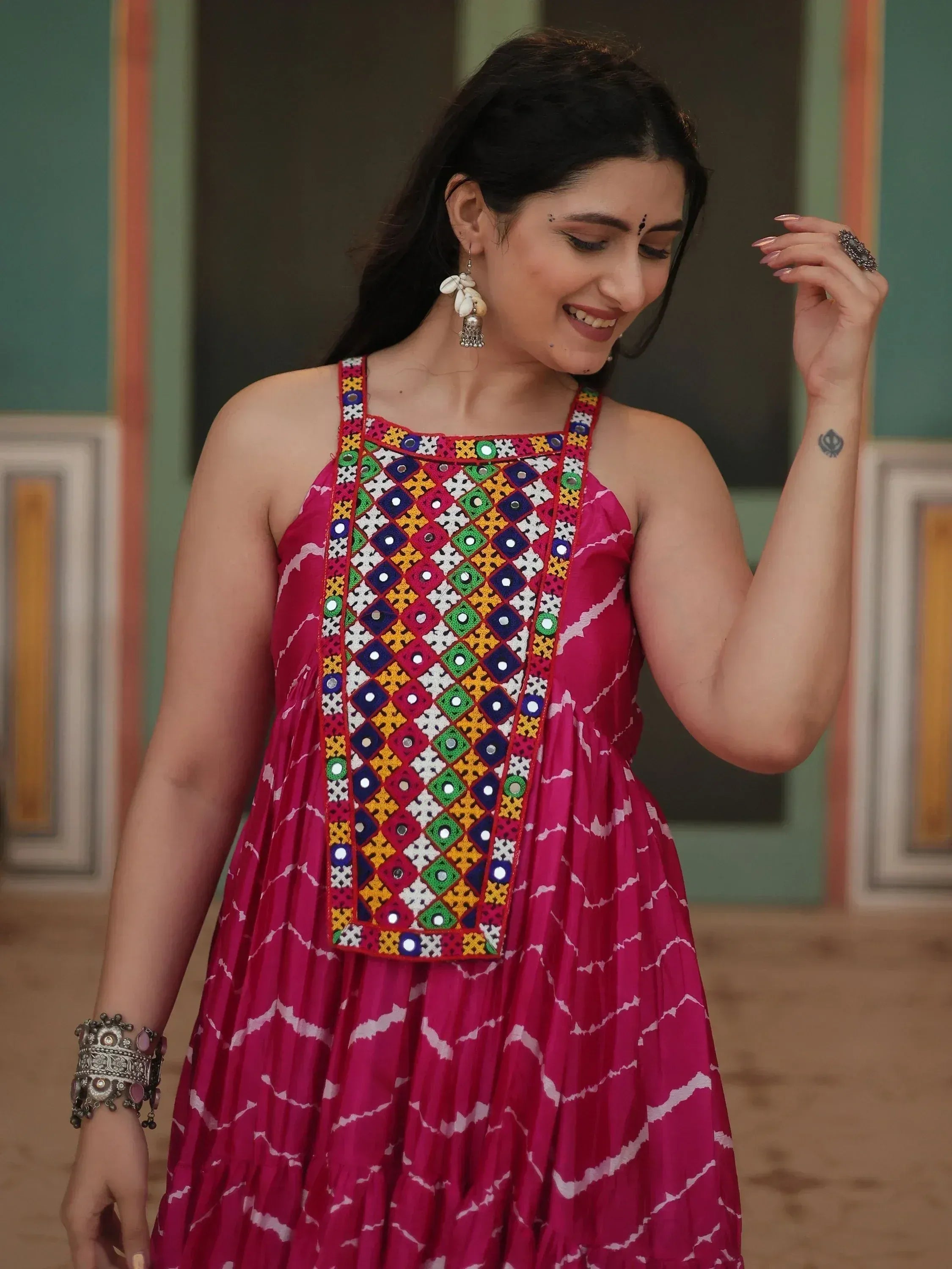 Pink ethnic gown with colorful mirror work and tie-dye print, perfect for Indian festive wear