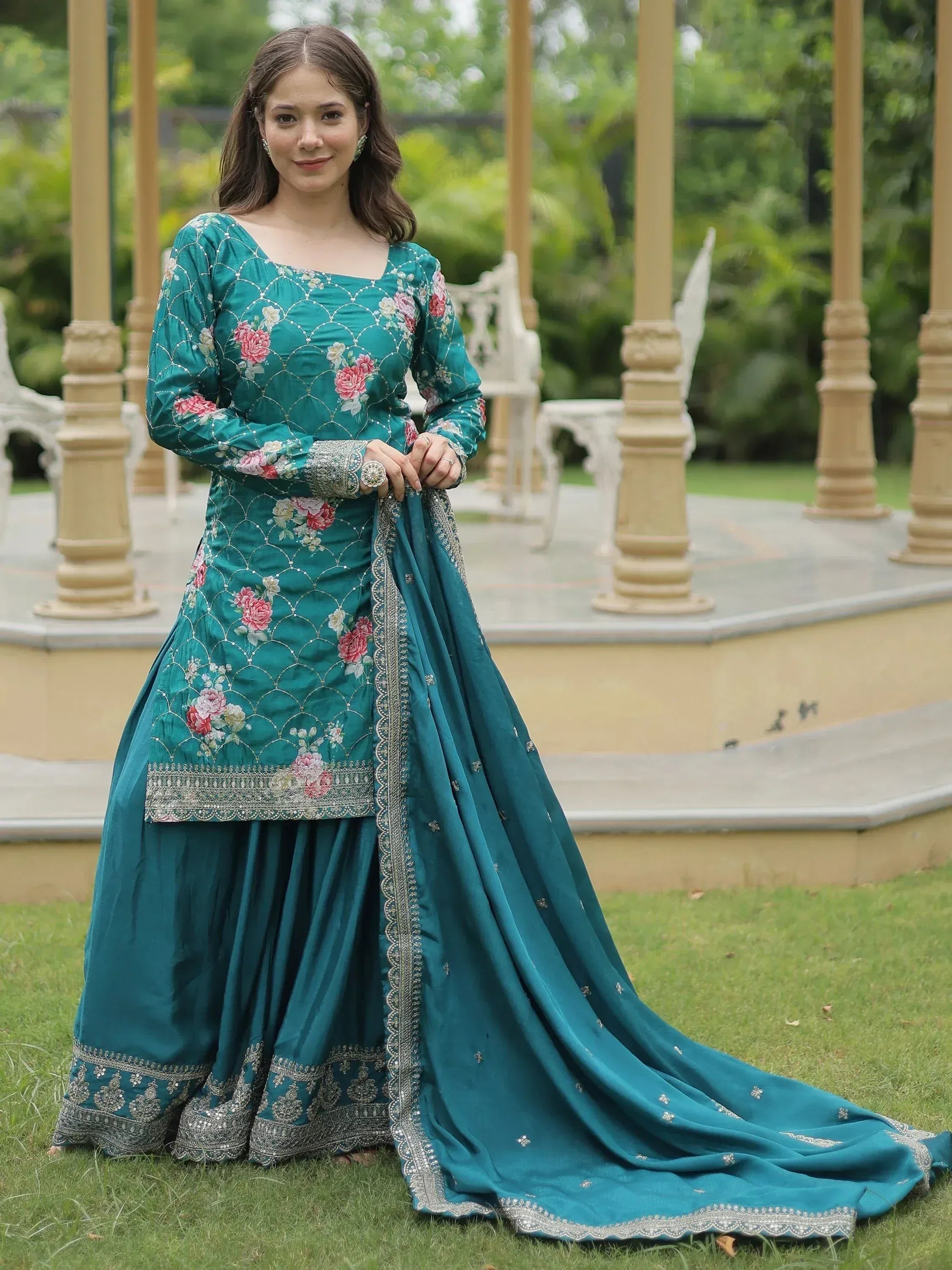 Teal floral embroidered salwar kameez with silver detailing, perfect for ethnic occasions