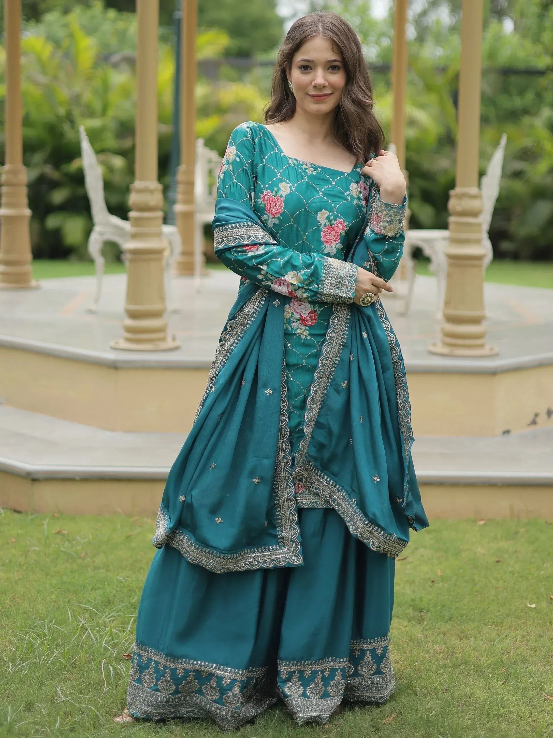 Teal floral embroidered salwar kameez with silver detailing, perfect for ethnic occasions