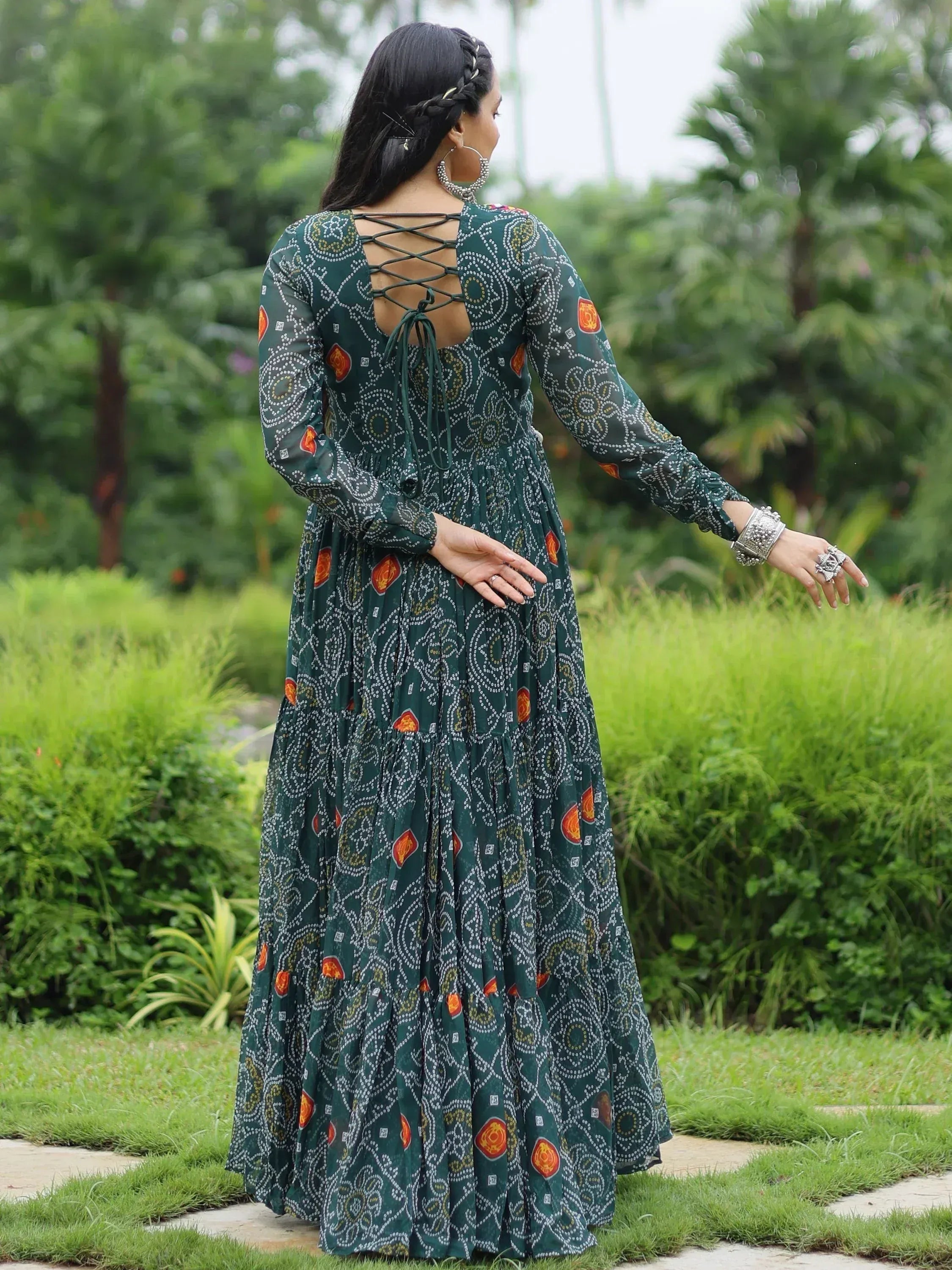 Green printed ethnic gown with criss-cross back, perfect for festive occasions