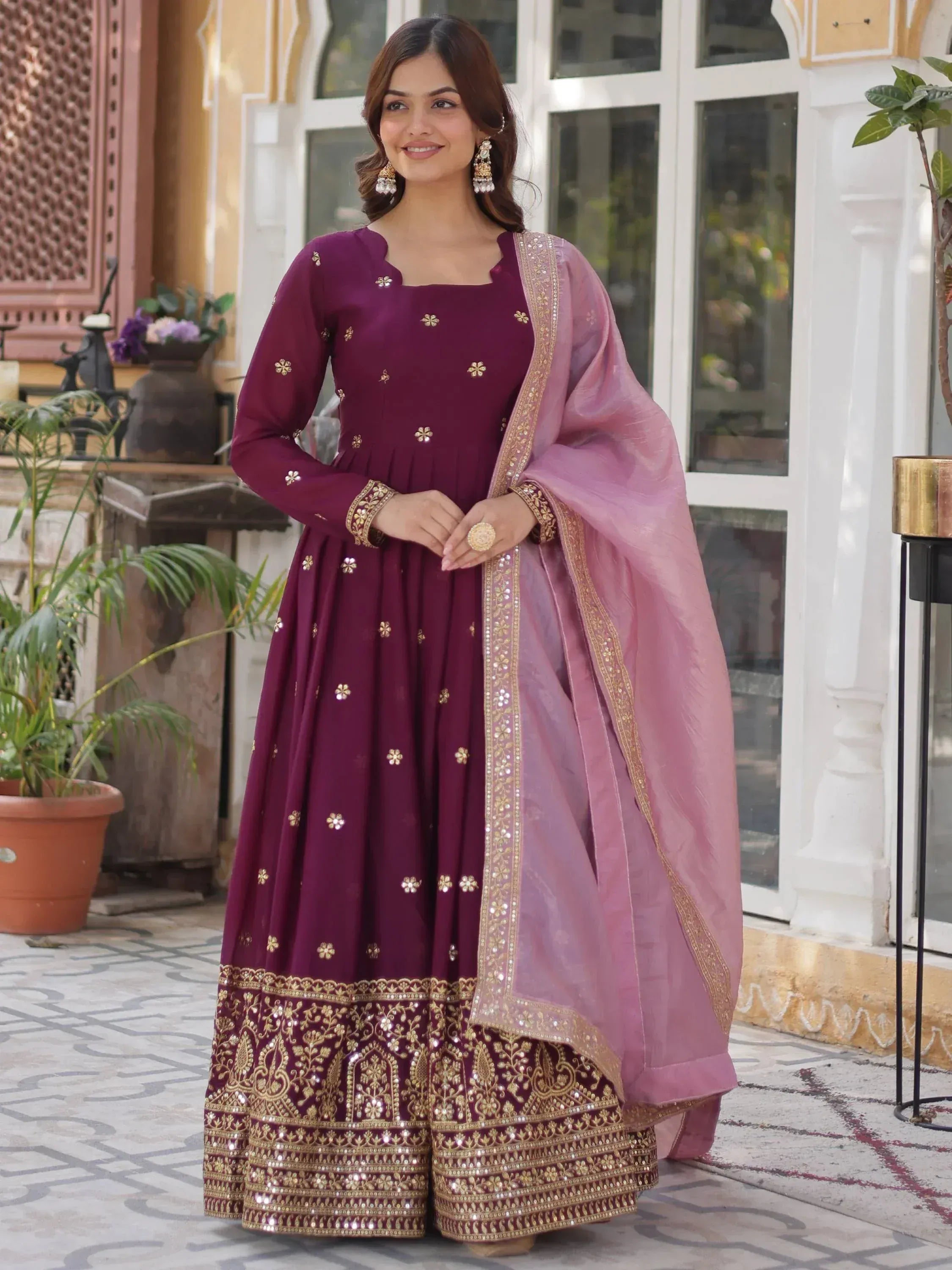 Elegant maroon anarkali with gold embroidery and pink dupatta, perfect for Indian ethnic occasions