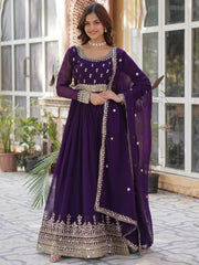Woman wearing a purple embroidered Indian ethnic gown, standing outdoors at Ethnic Plus.
