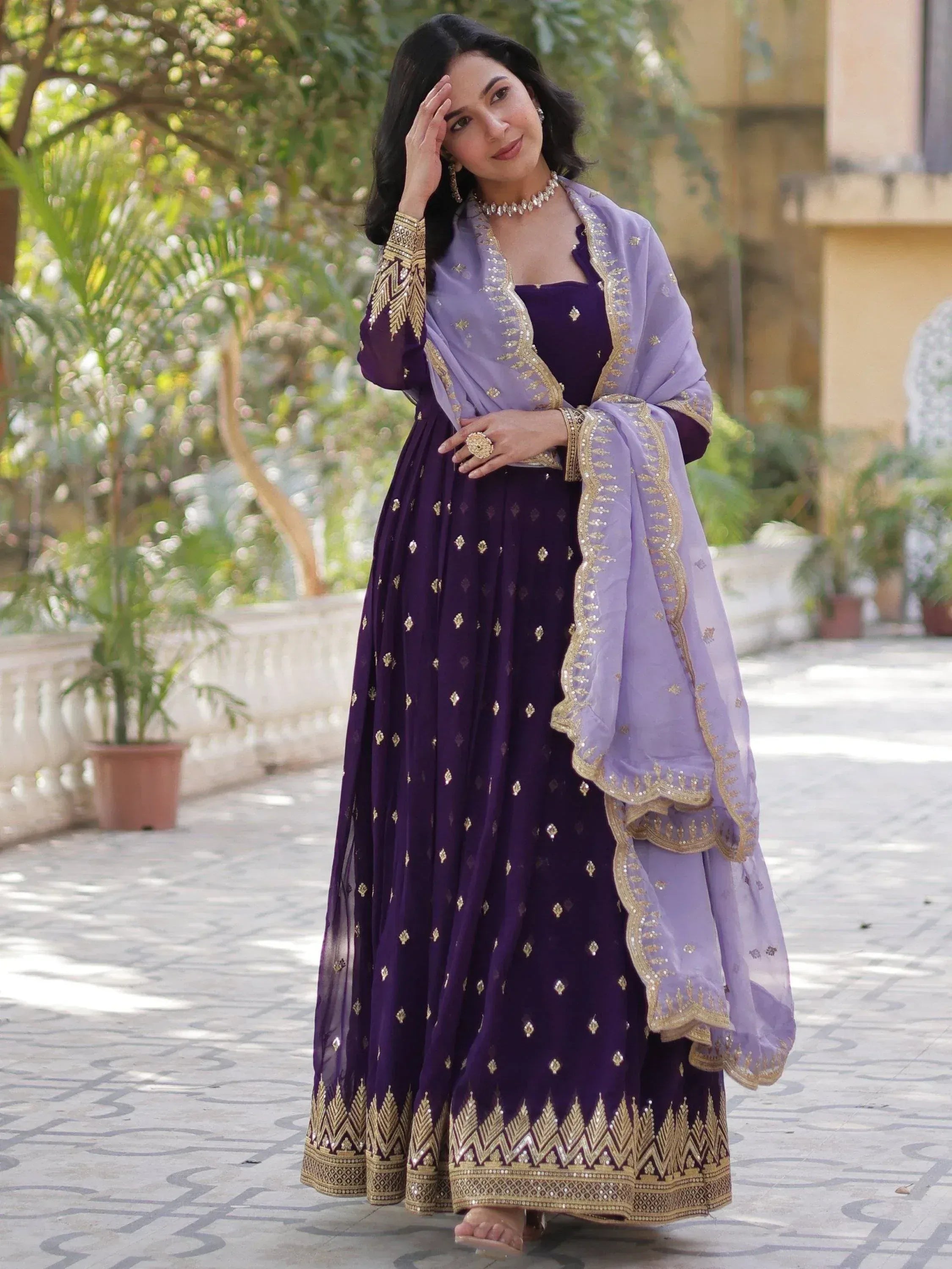 Purple ethnic anarkali with gold embroidery and lavender dupatta, perfect for Indian weddings or festive occasions.
