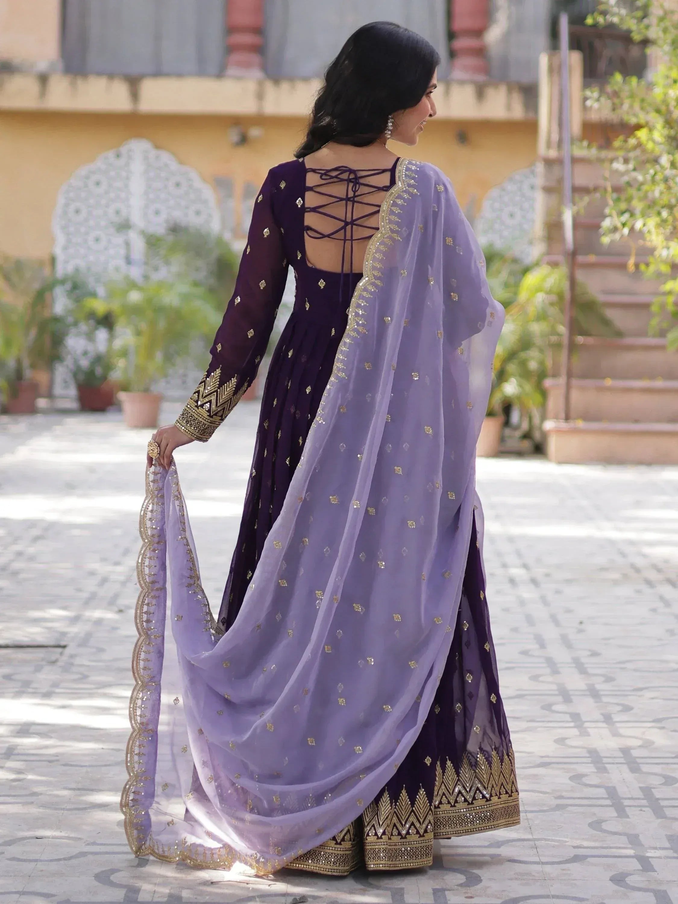 Elegant purple ethnic gown with gold embroidery and lace-up back, paired with sheer dupatta