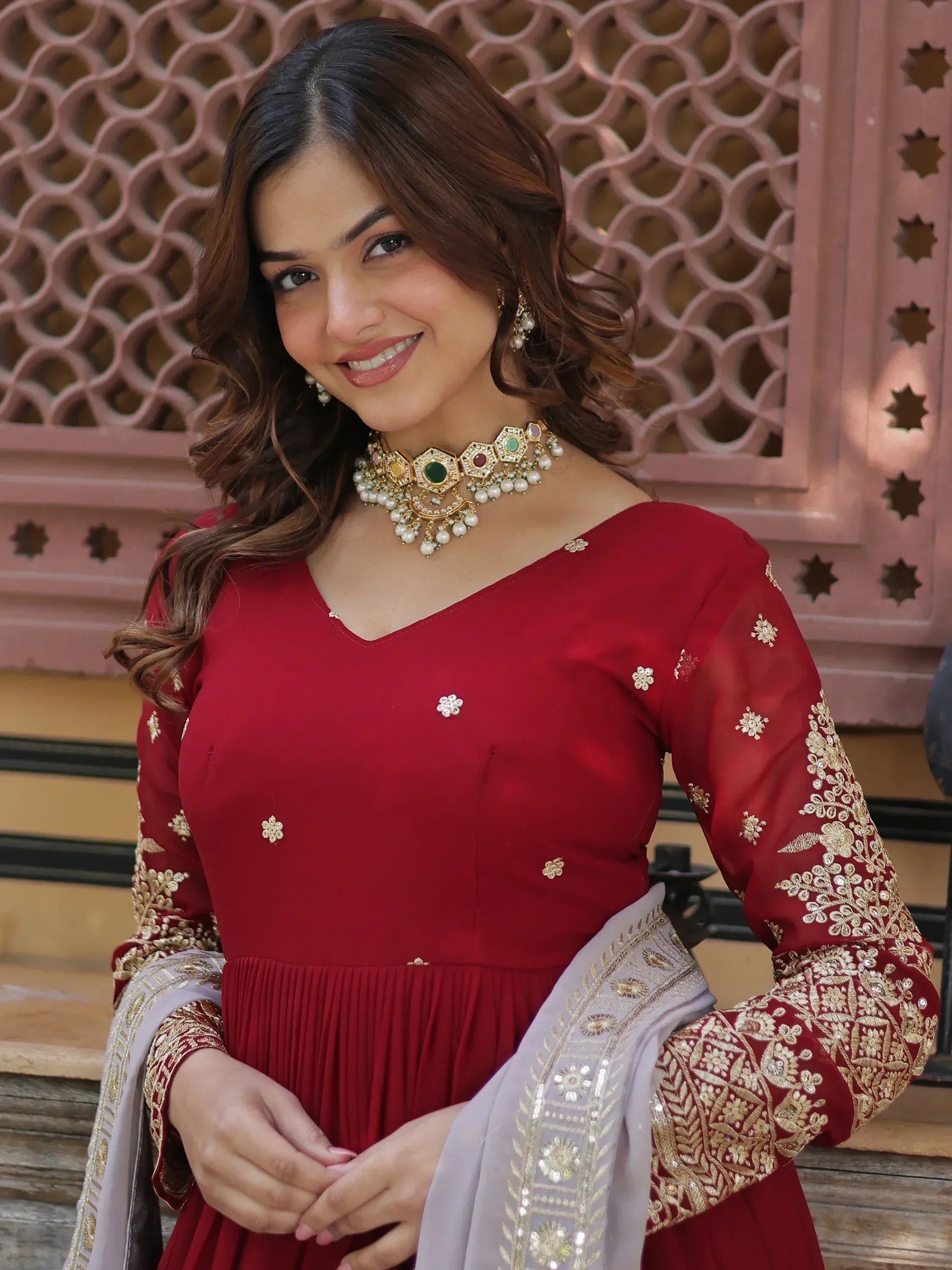 Woman wearing red embroidered Anarkali suit with gold dupatta, Indian ethnic fashion