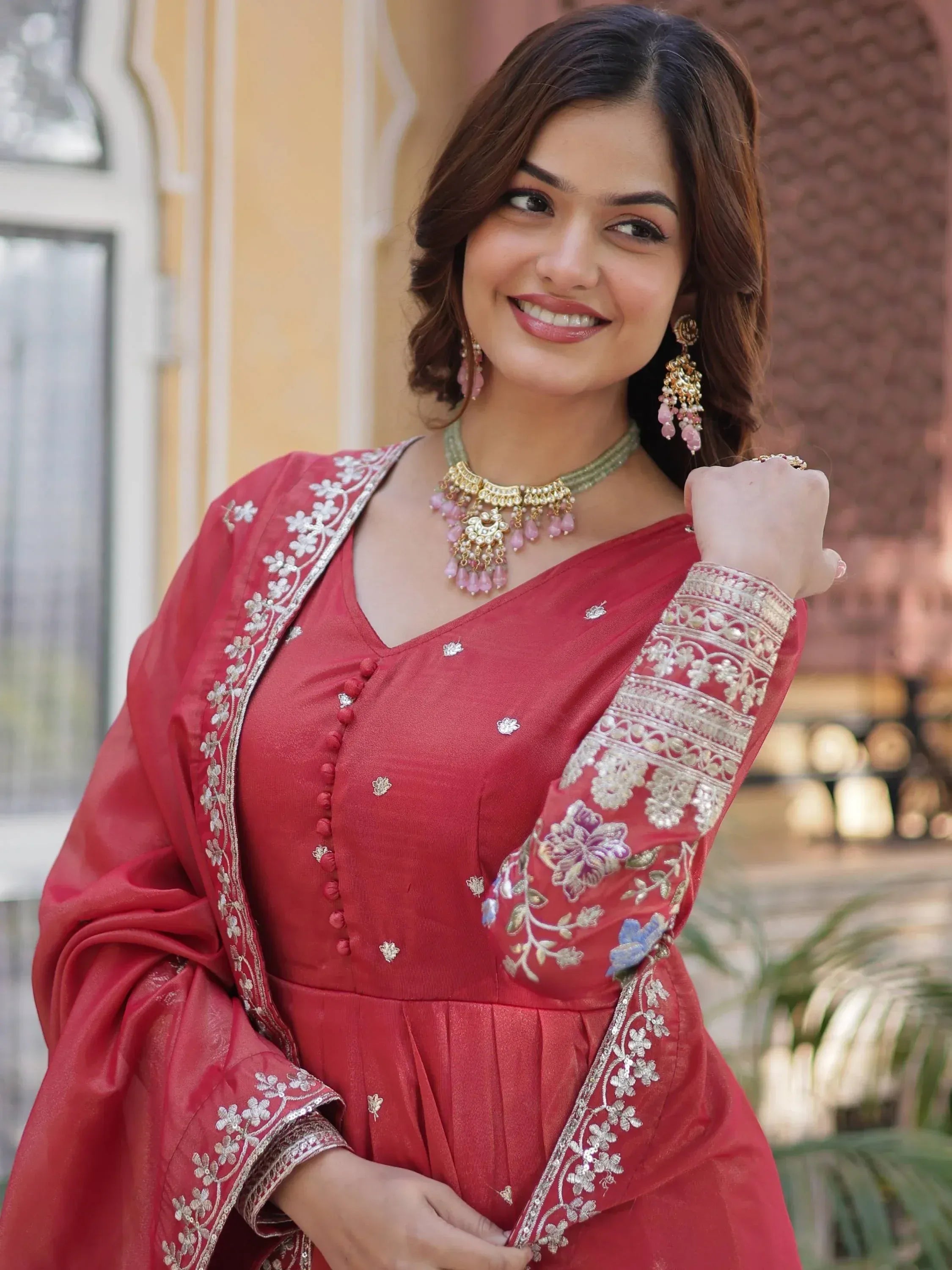 Red embroidered ethnic gown with floral detailing, perfect for Indian celebrations and festive occasions.