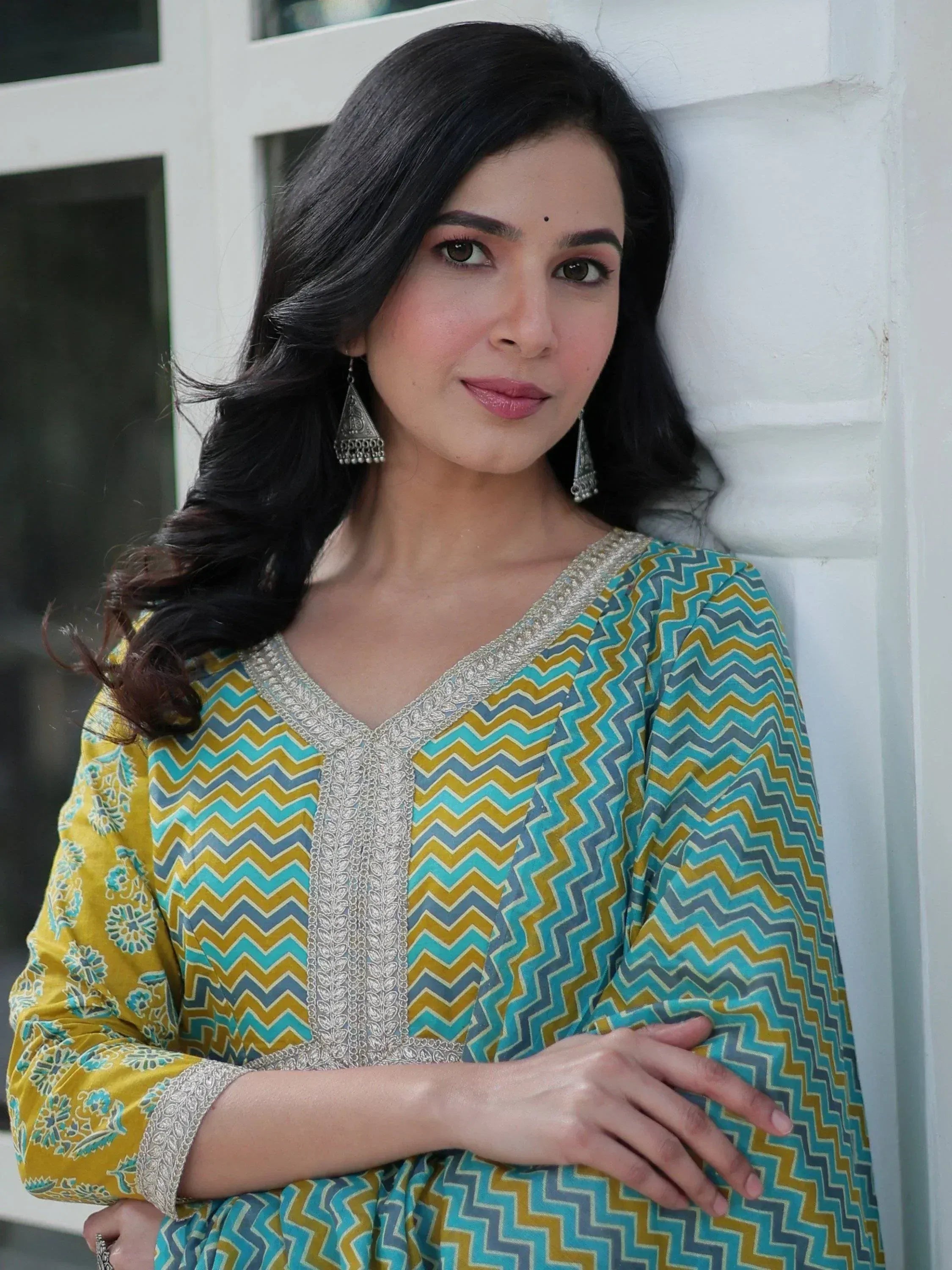 Woman in colorful ethnic kurti with chevron print and silver embroidery, perfect for Indian wear