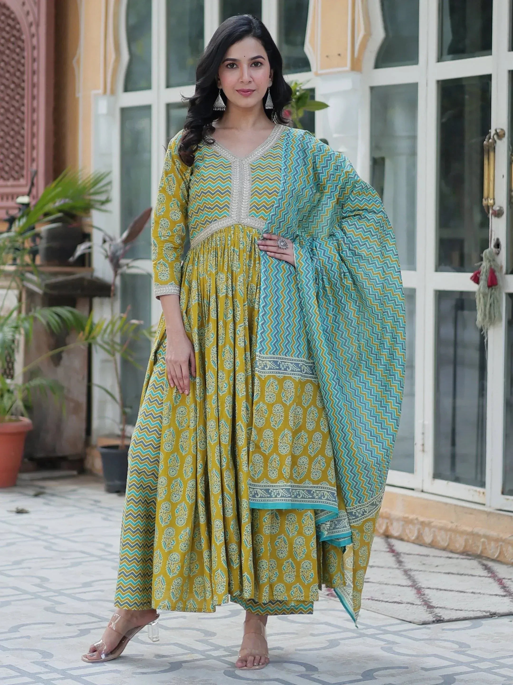 Yellow and teal printed ethnic gown with zigzag dupatta, perfect for Indian occasions