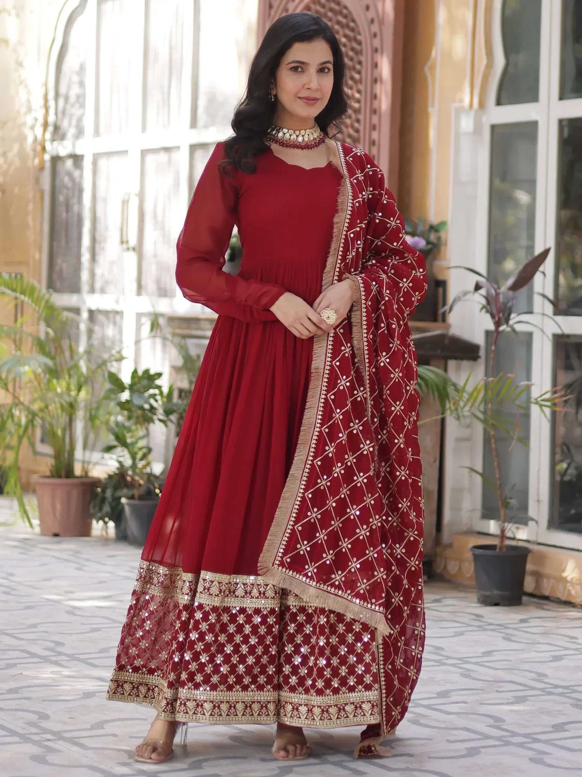 Red ethnic anarkali gown with gold embroidery and dupatta, perfect for Indian weddings and festivals