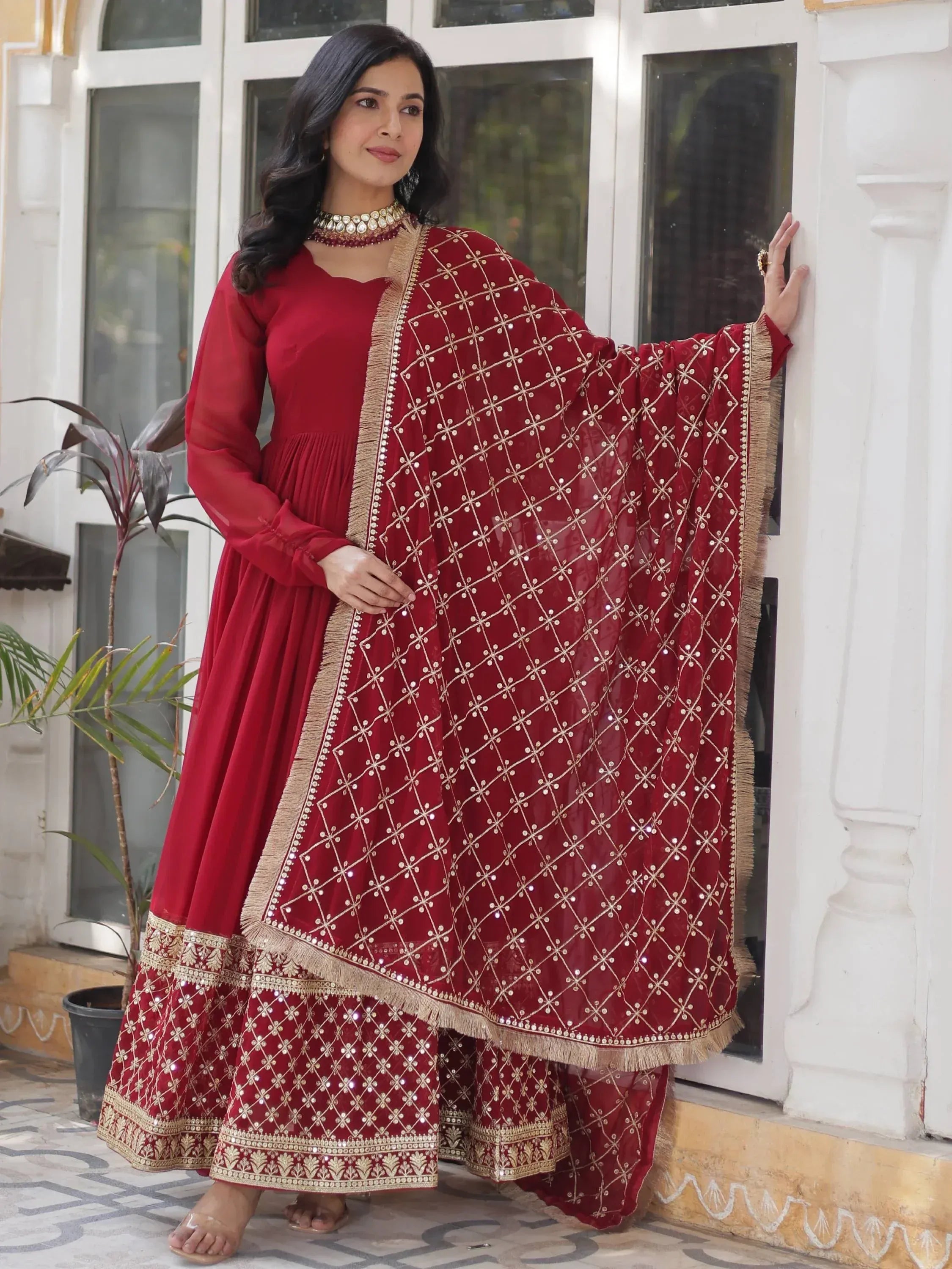 Red ethnic anarkali suit with gold embroidery and sequin dupatta, perfect for Indian weddings and festive occasions