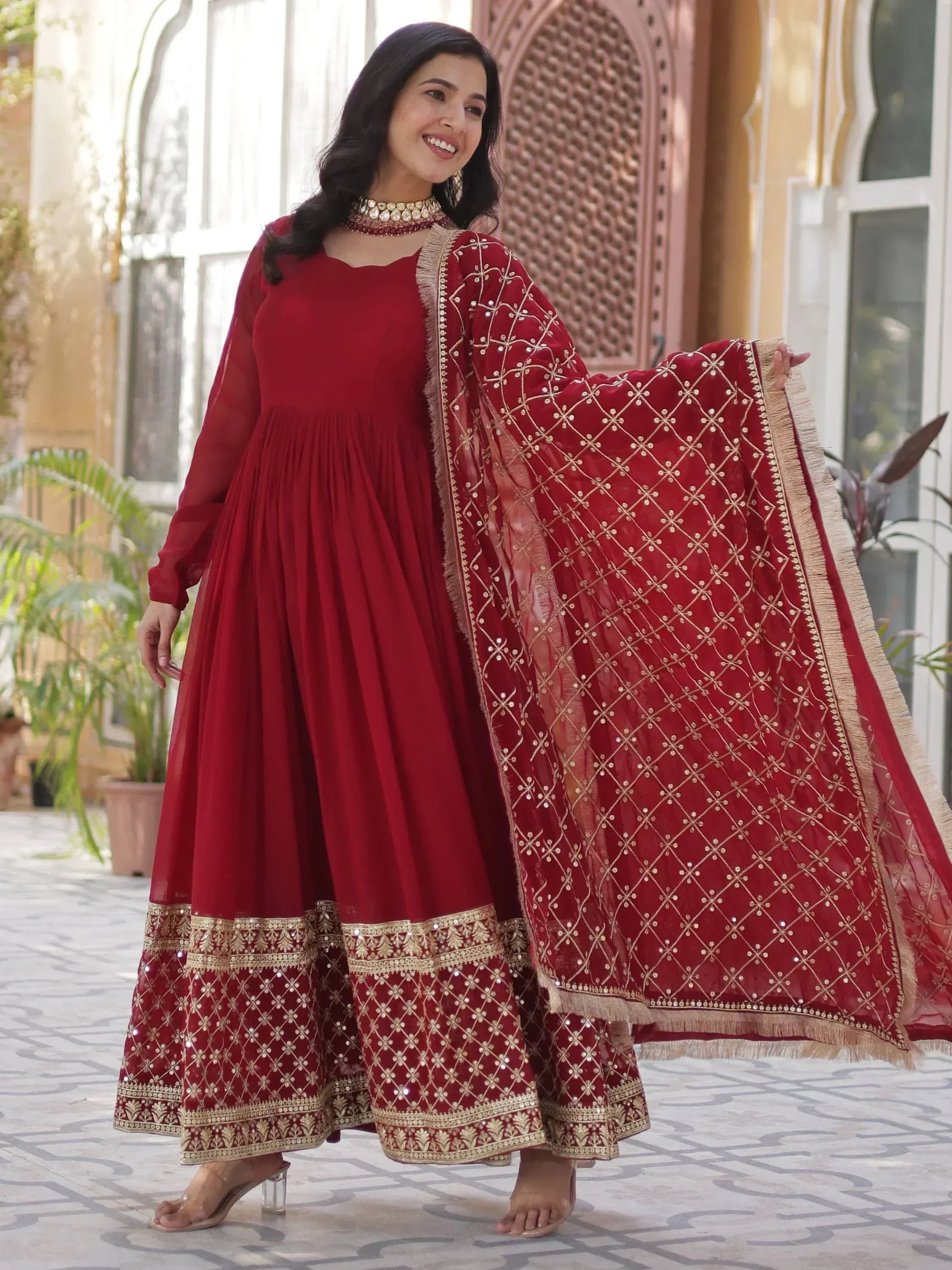 Red embroidered anarkali suit with gold detailing and matching dupatta, ideal for Indian ethnic occasions