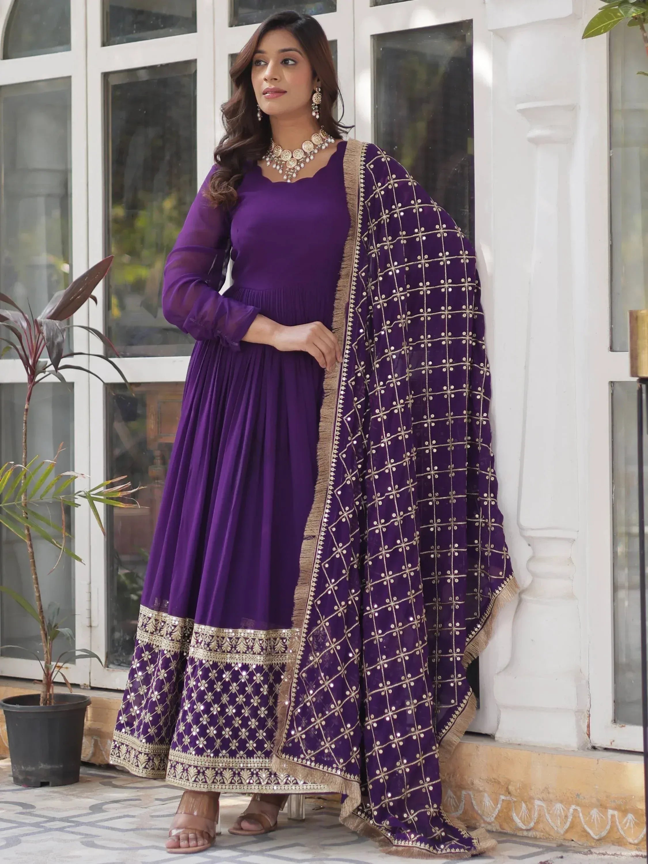 Purple ethnic anarkali suit with gold embroidery and matching dupatta, perfect for Indian occasions