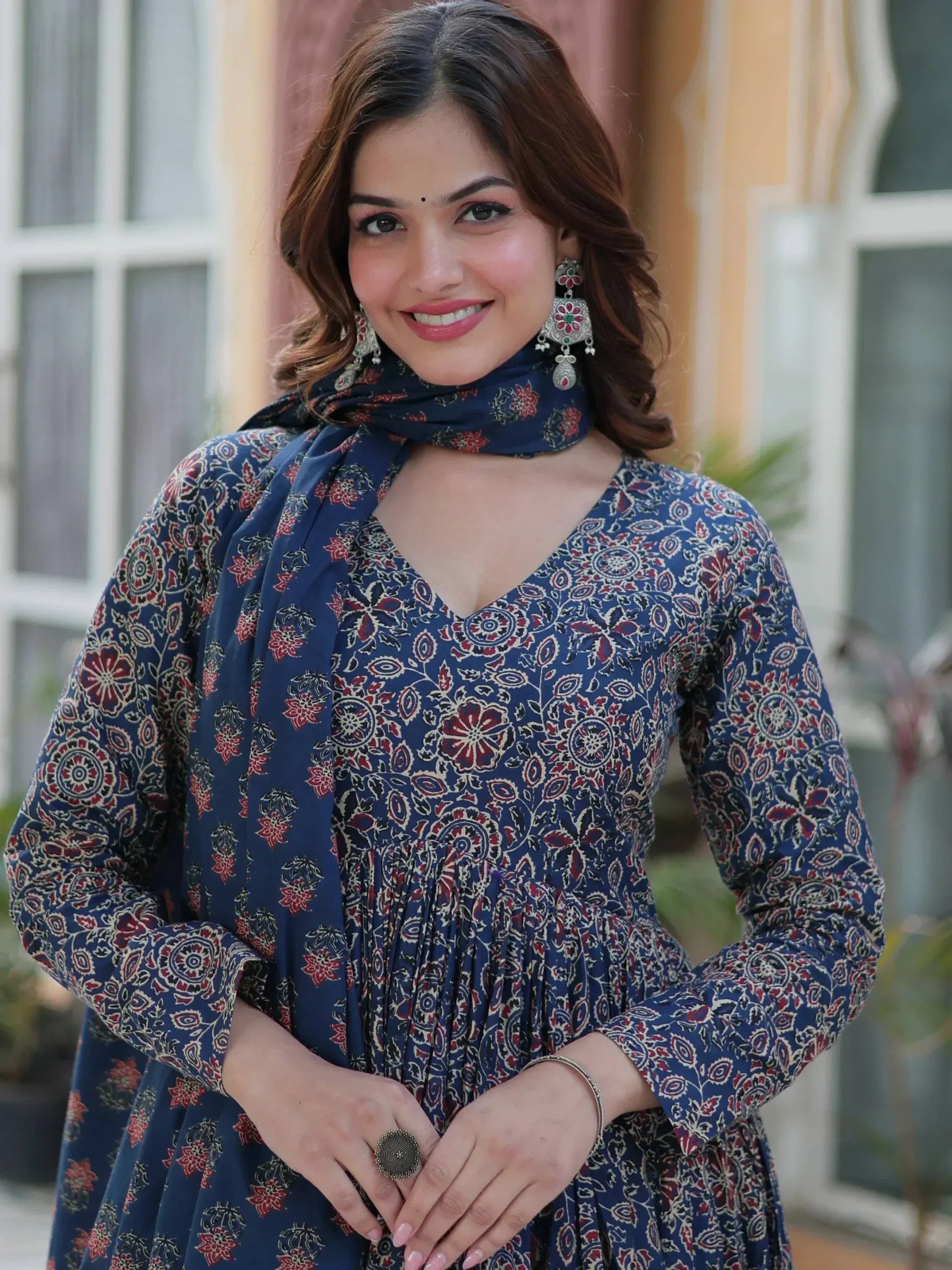 Woman in blue floral ethnic gown with matching dupatta, traditional Indian wear for festive occasions