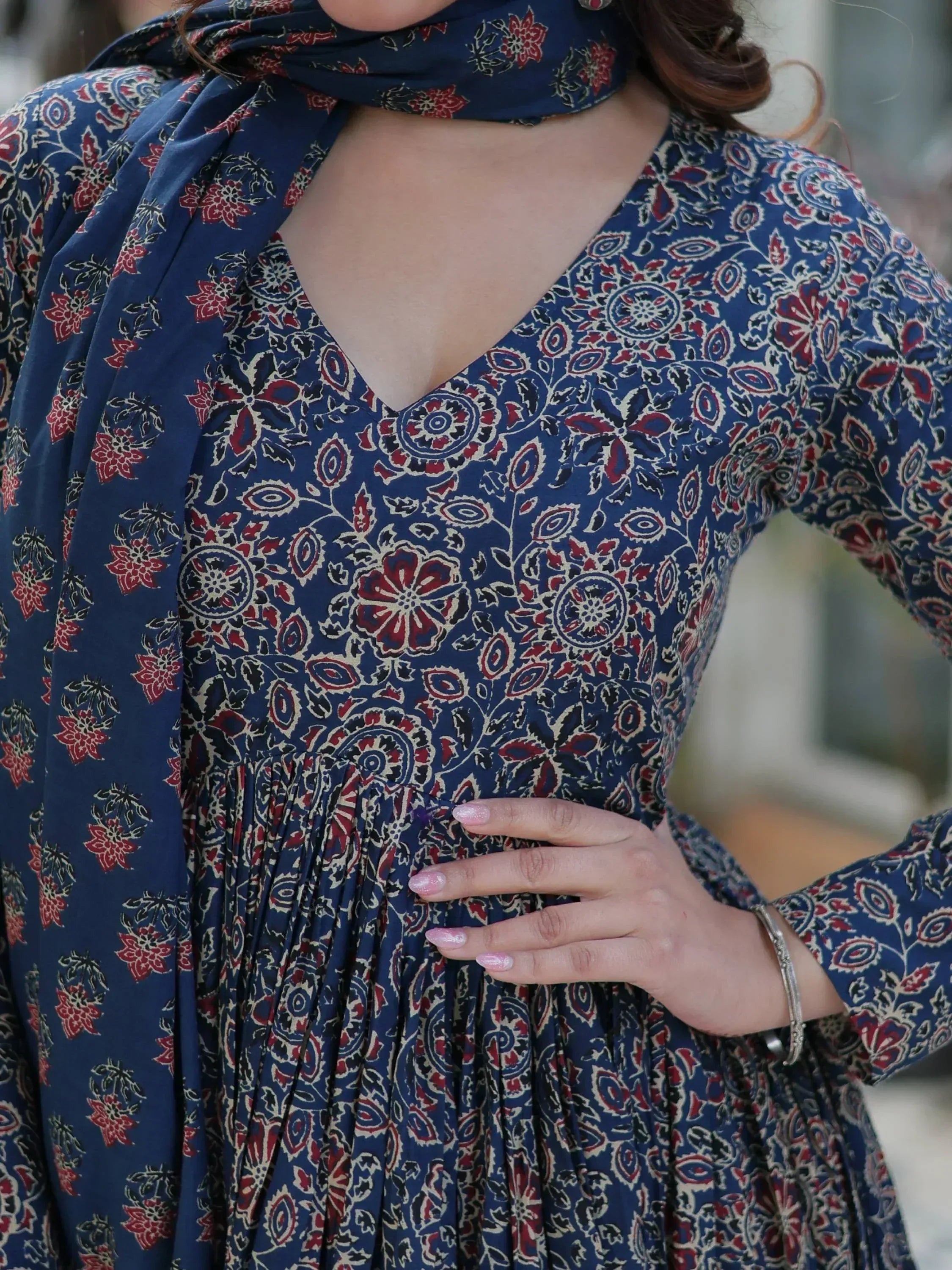 Blue floral printed ethnic gown with matching dupatta, V-neck design, and pleated waist for women