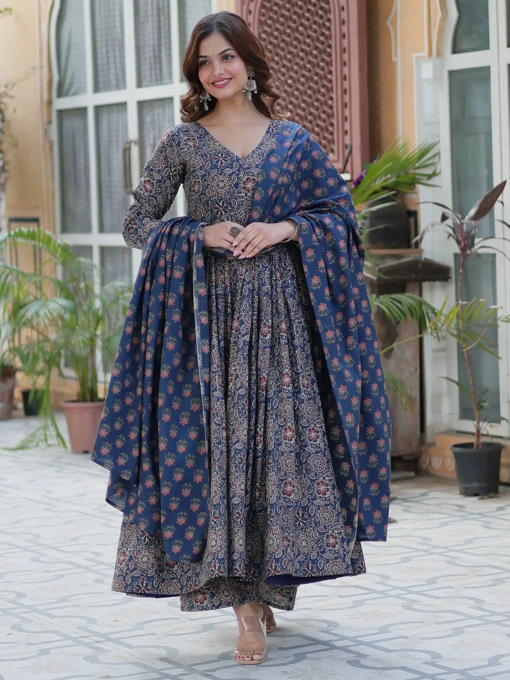 Woman in blue floral printed ethnic gown with cape, perfect for Indian occasions and festive wear