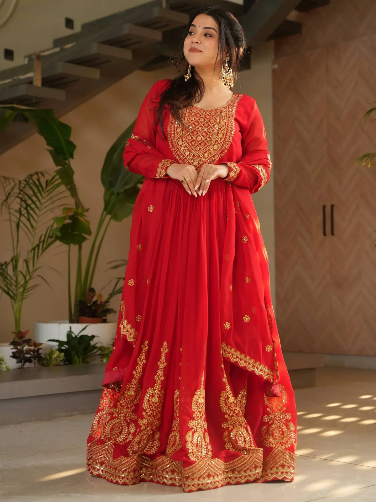 Red ethnic gown with gold embroidery, perfect for festive occasions and traditional events.