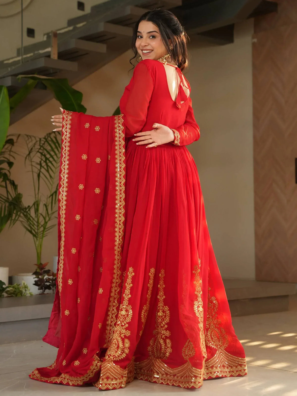 Red ethnic gown with gold embroidery, perfect for Indian weddings and festive occasions