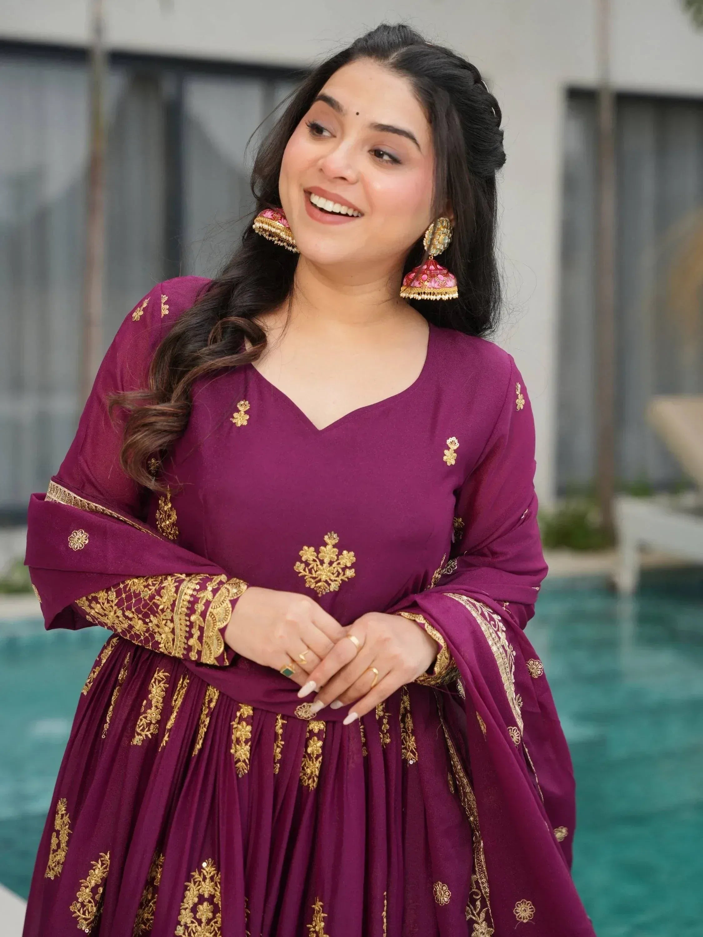 Elegant maroon ethnic gown with gold embroidery, perfect for Indian celebrations