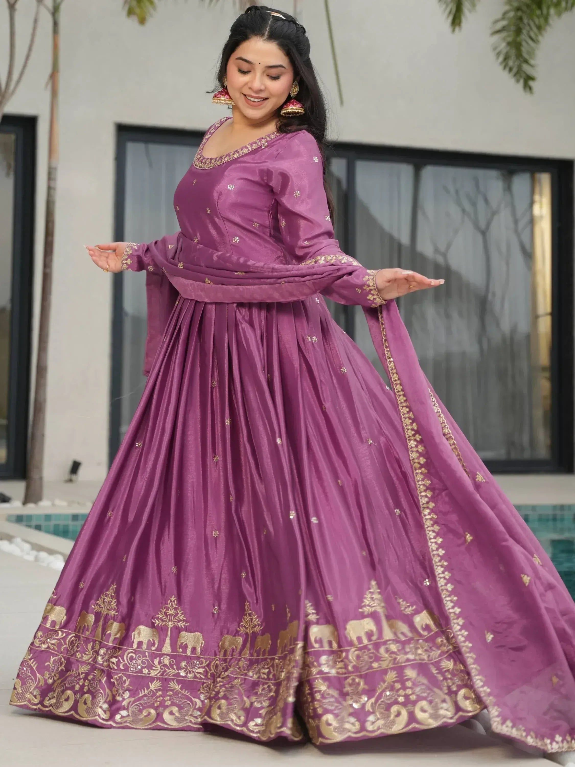 Purple Indian ethnic anarkali with gold elephant print, perfect for weddings and festive occasions.