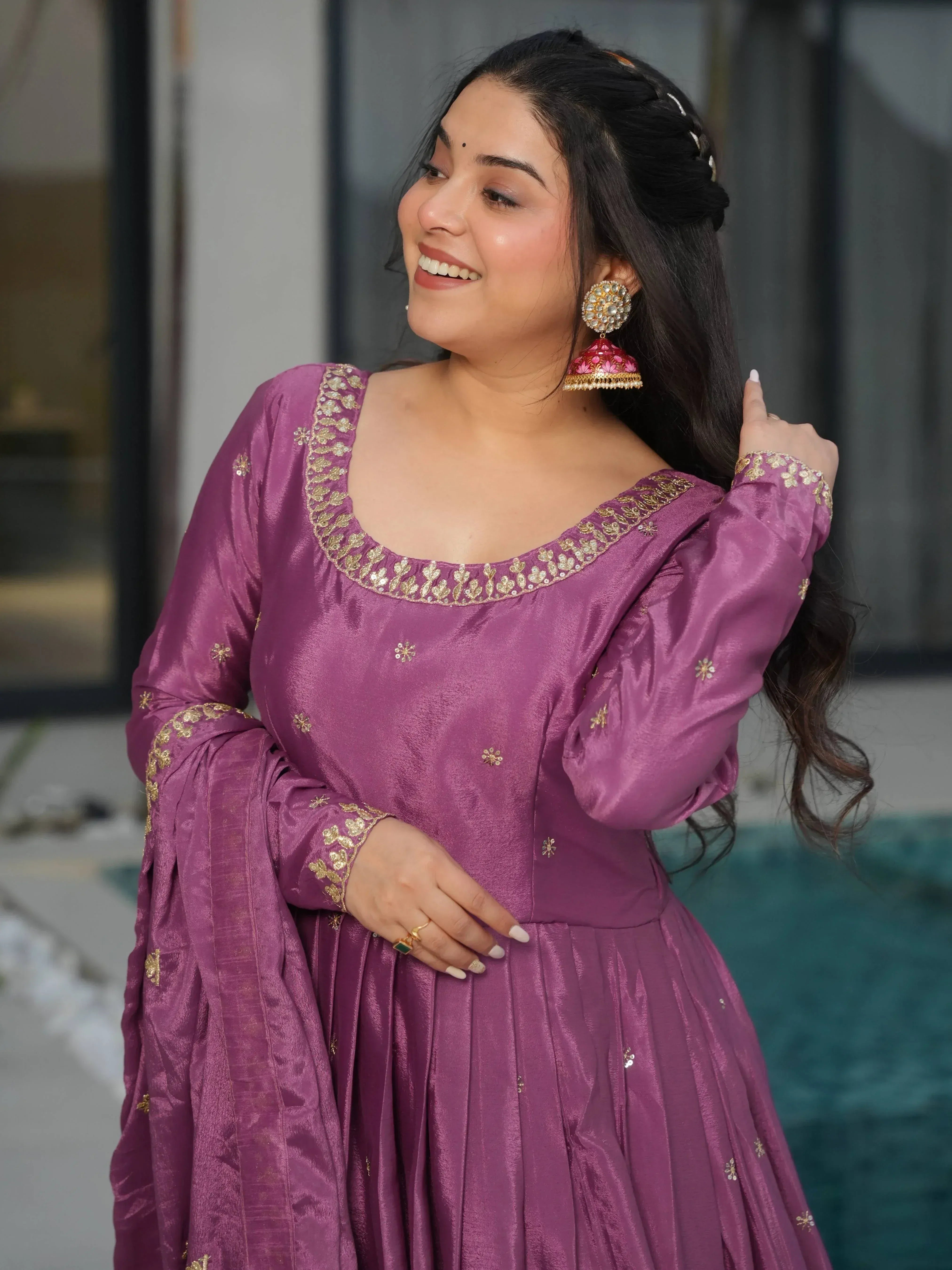 Woman in purple ethnic gown with gold embroidery, perfect for Indian festive occasions and weddings.