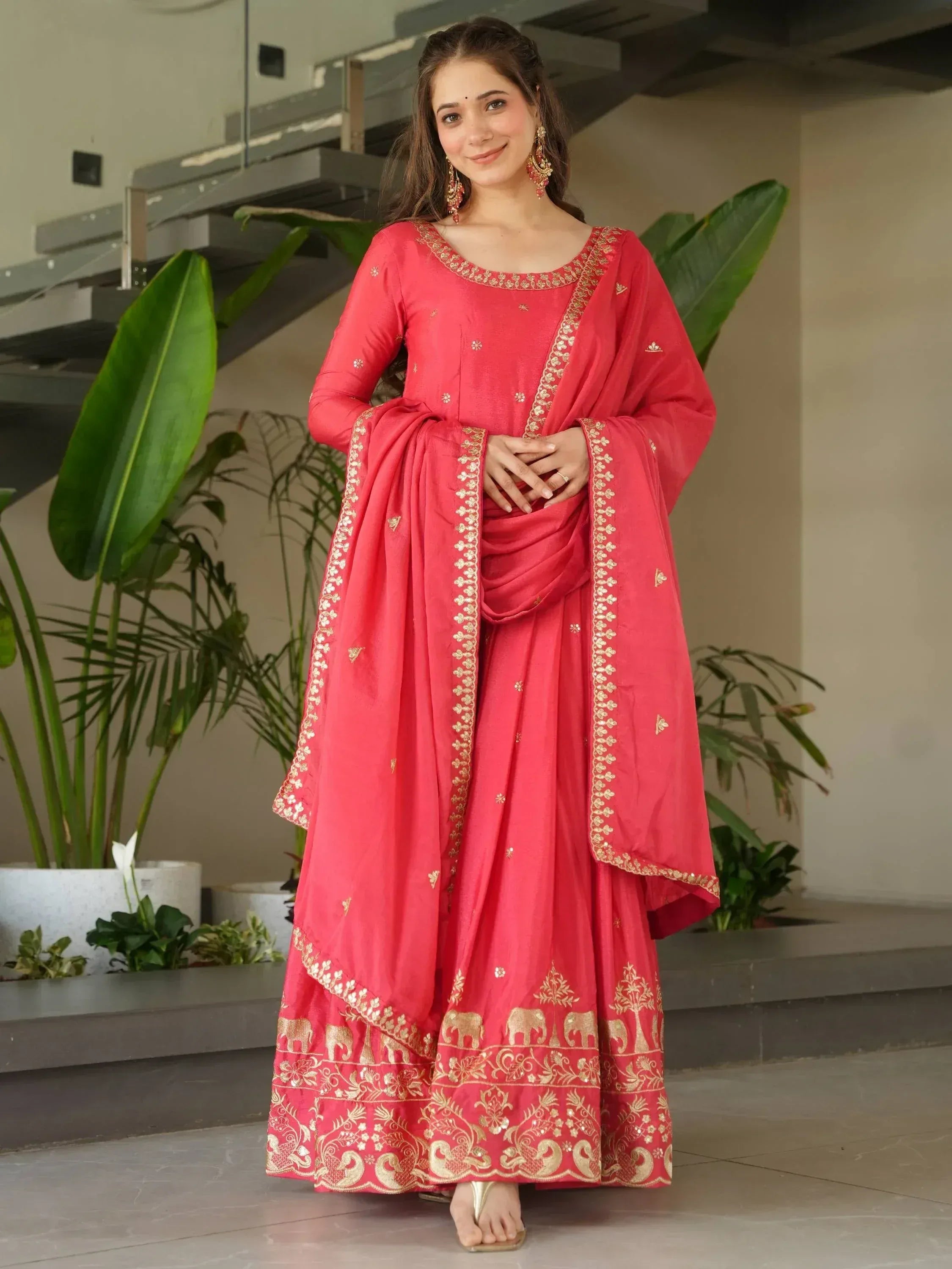 Red ethnic salwar kameez with gold embroidery and elephant motifs, perfect for Indian festive occasions.