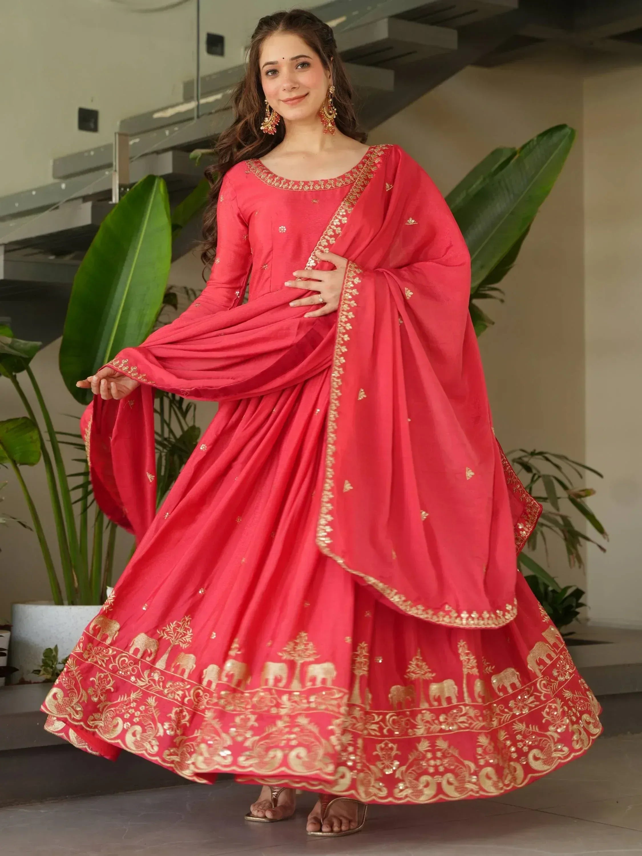 Red ethnic gown with gold elephant print, perfect for Indian weddings and festive occasions