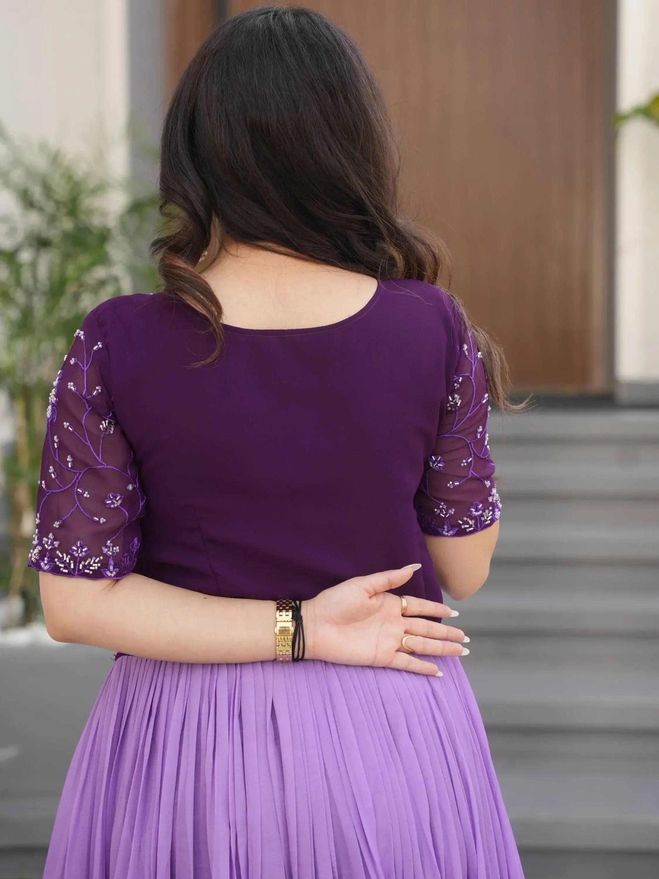 Purple ethnic gown with embroidered sleeves and pleated skirt, perfect for Indian occasions