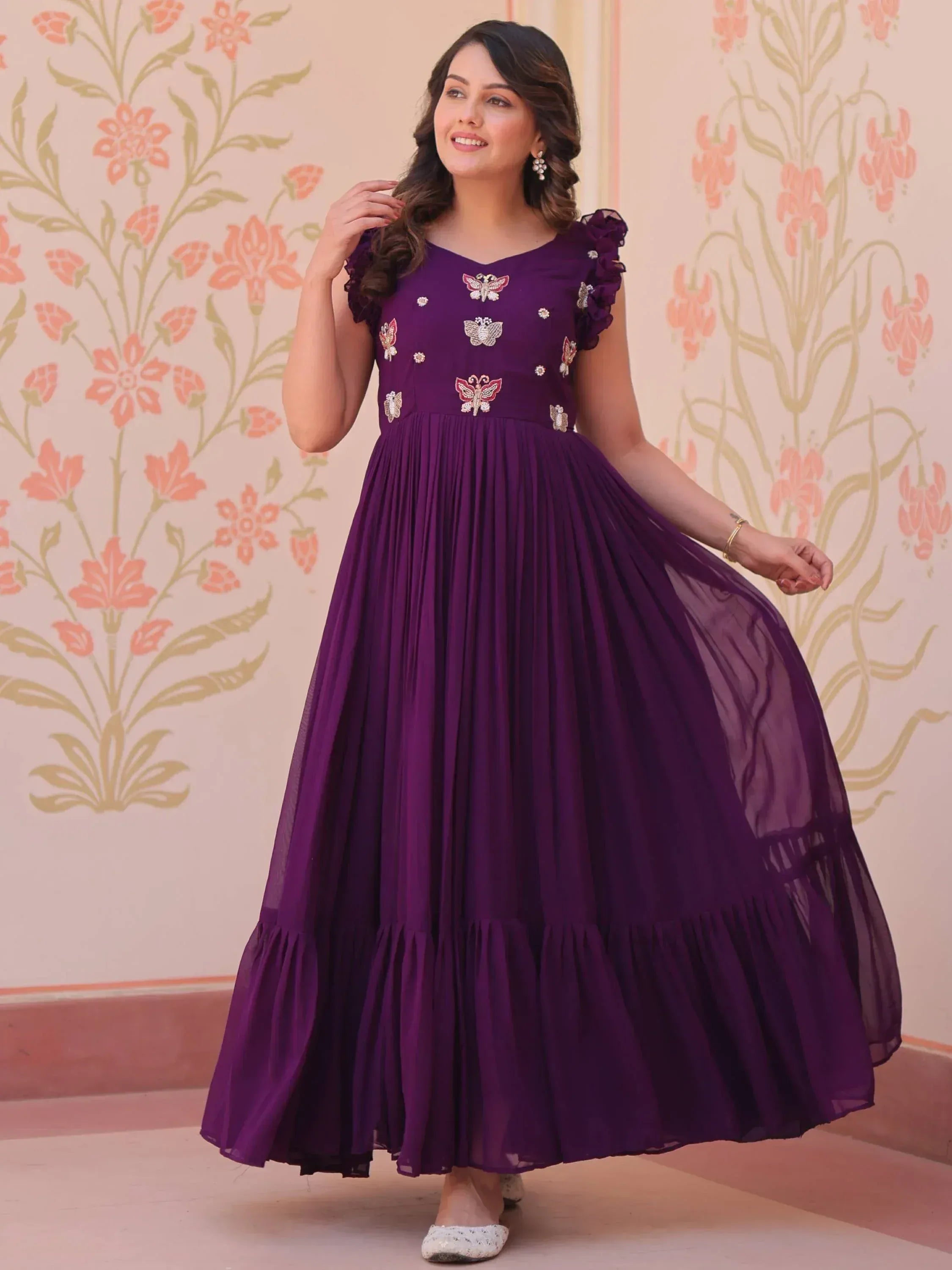Purple ethnic gown with butterfly embroidery, ruffled sleeves, and pleated skirt for festive occasions