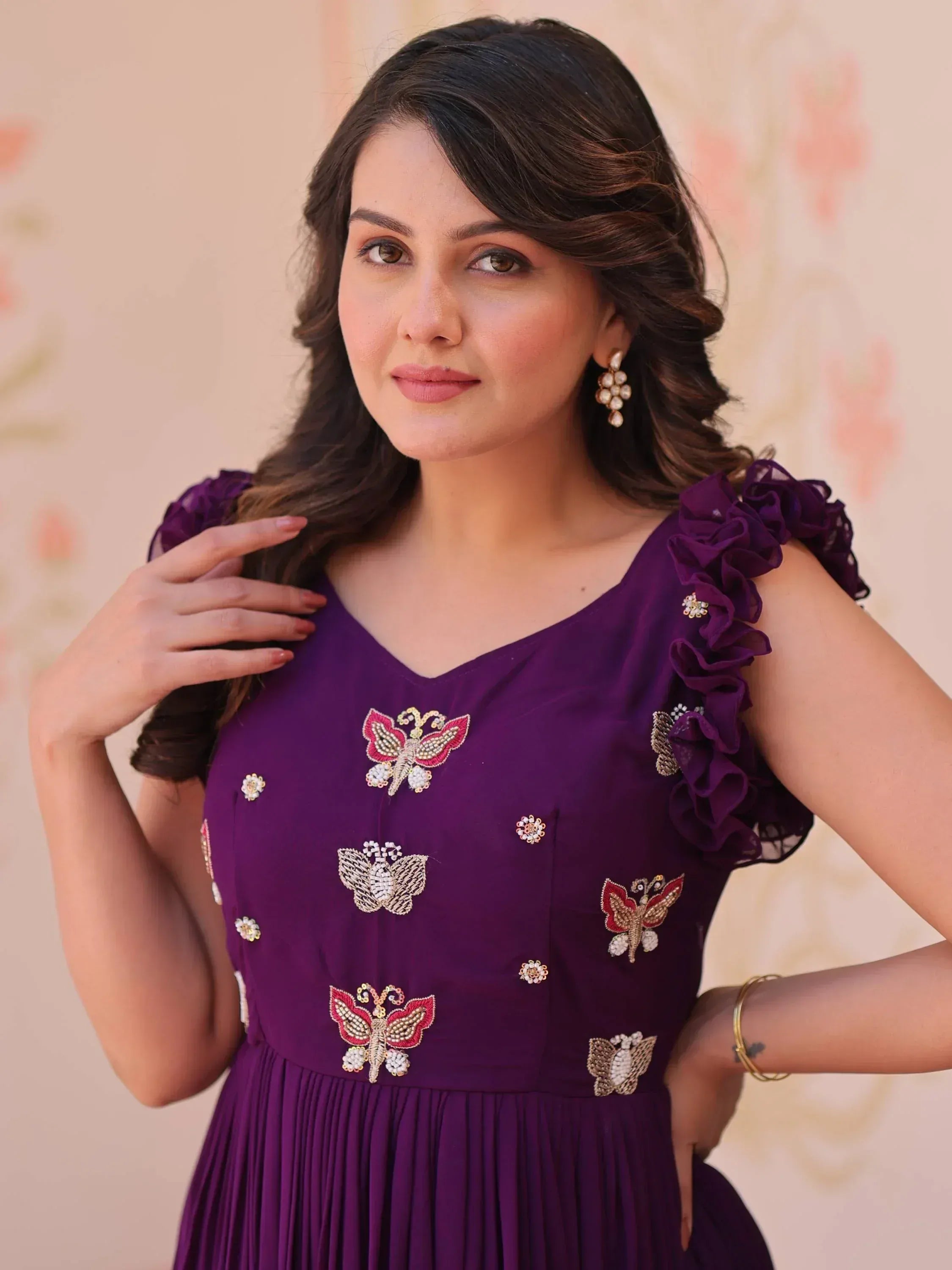 Purple ethnic gown with butterfly embroidery, ruffled sleeves, and pleated skirt for Indian occasions