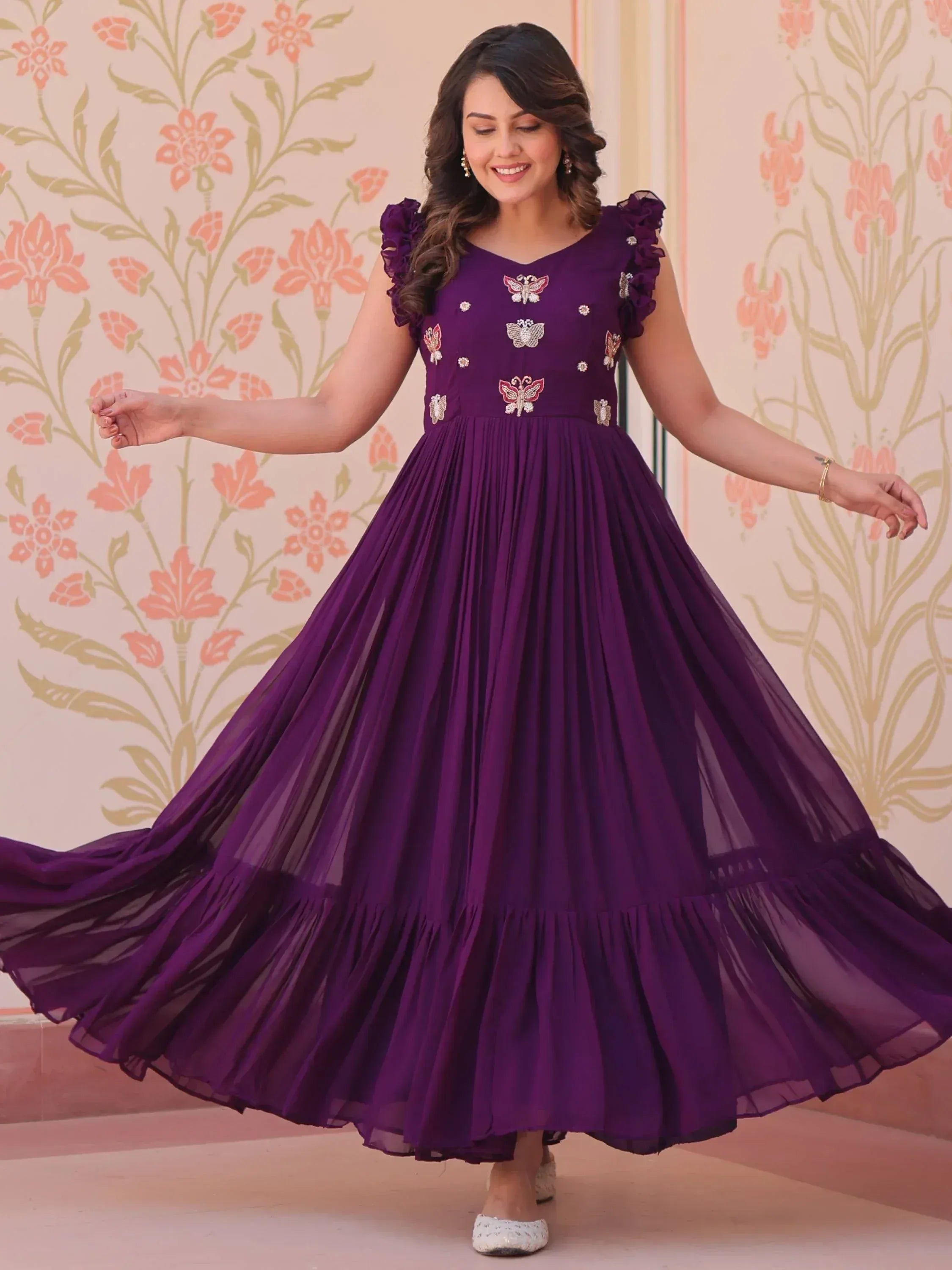Purple ethnic gown with butterfly embroidery, ruffled sleeves, and pleated skirt for festive occasions