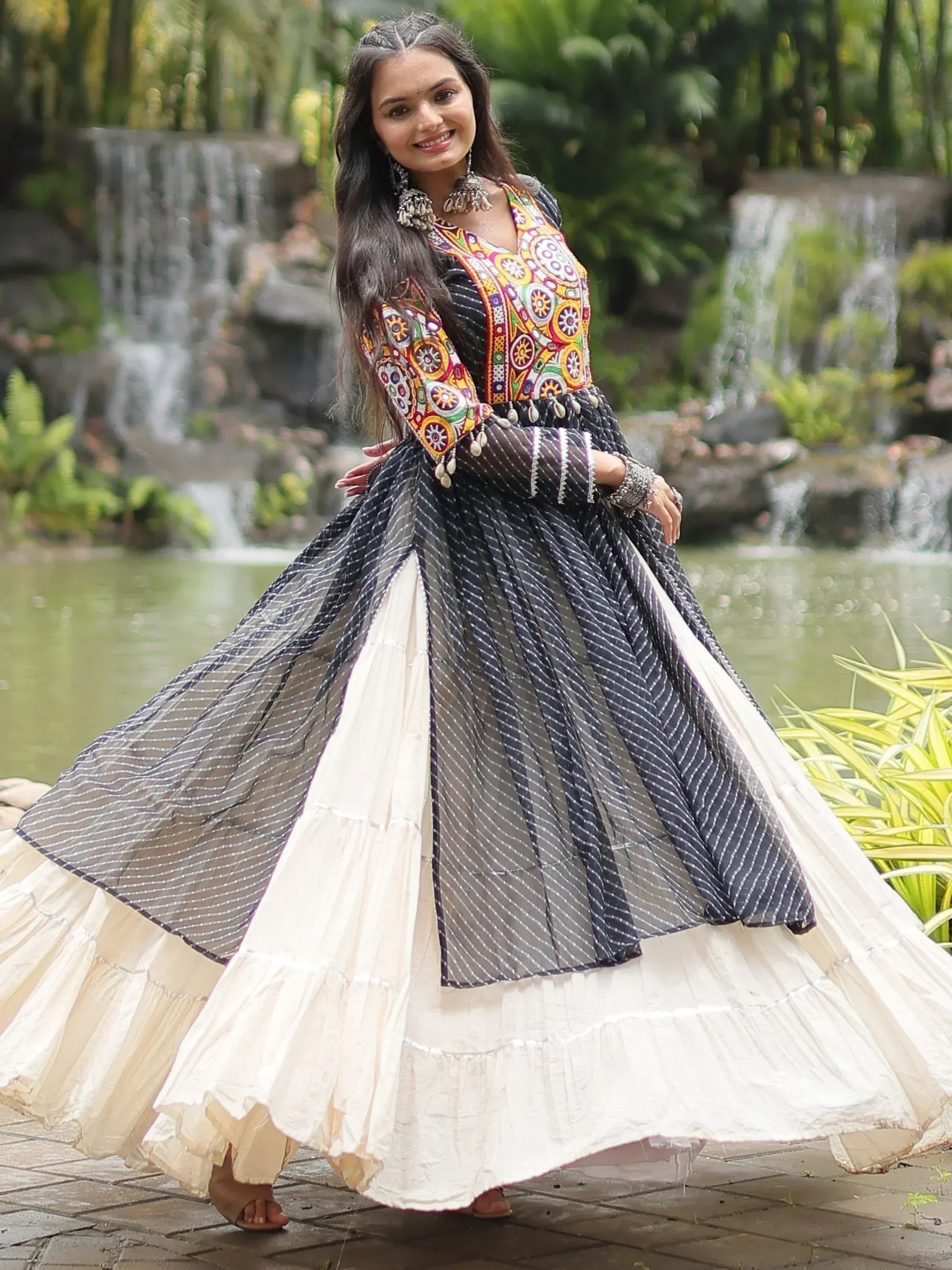 Woman in colorful embroidered ethnic gown with layered skirt, perfect for Indian festive occasions