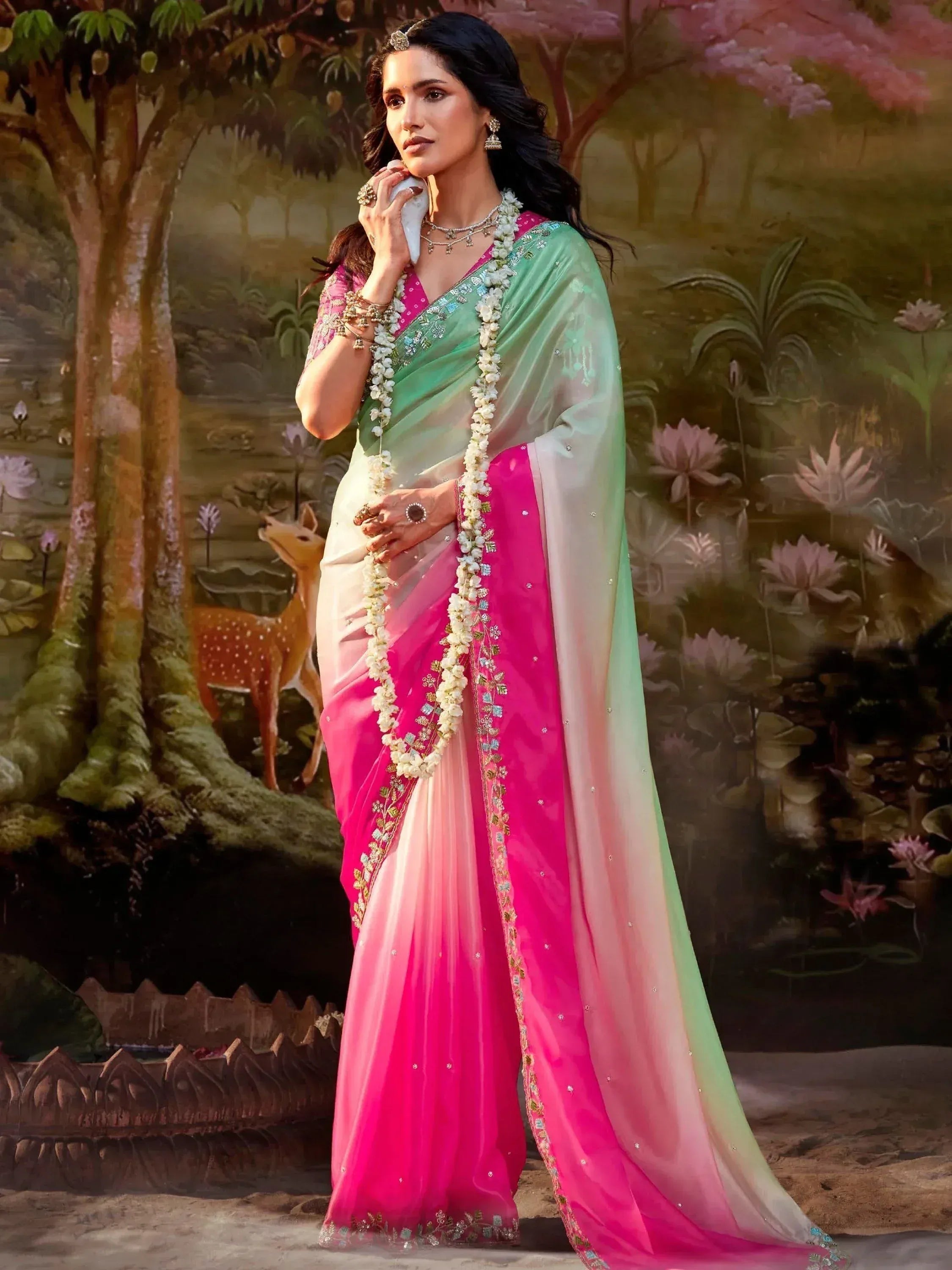 Woman in pink and green ombre saree with floral embroidery, traditional Indian ethnic wear