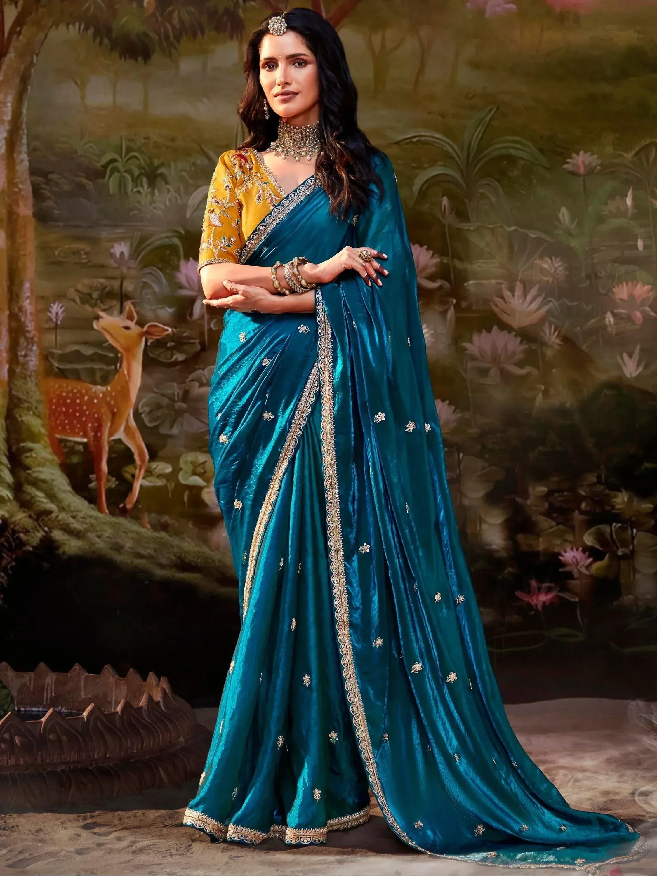 Teal velvet saree with gold embroidery, paired with yellow blouse, perfect for Indian ethnic occasions.