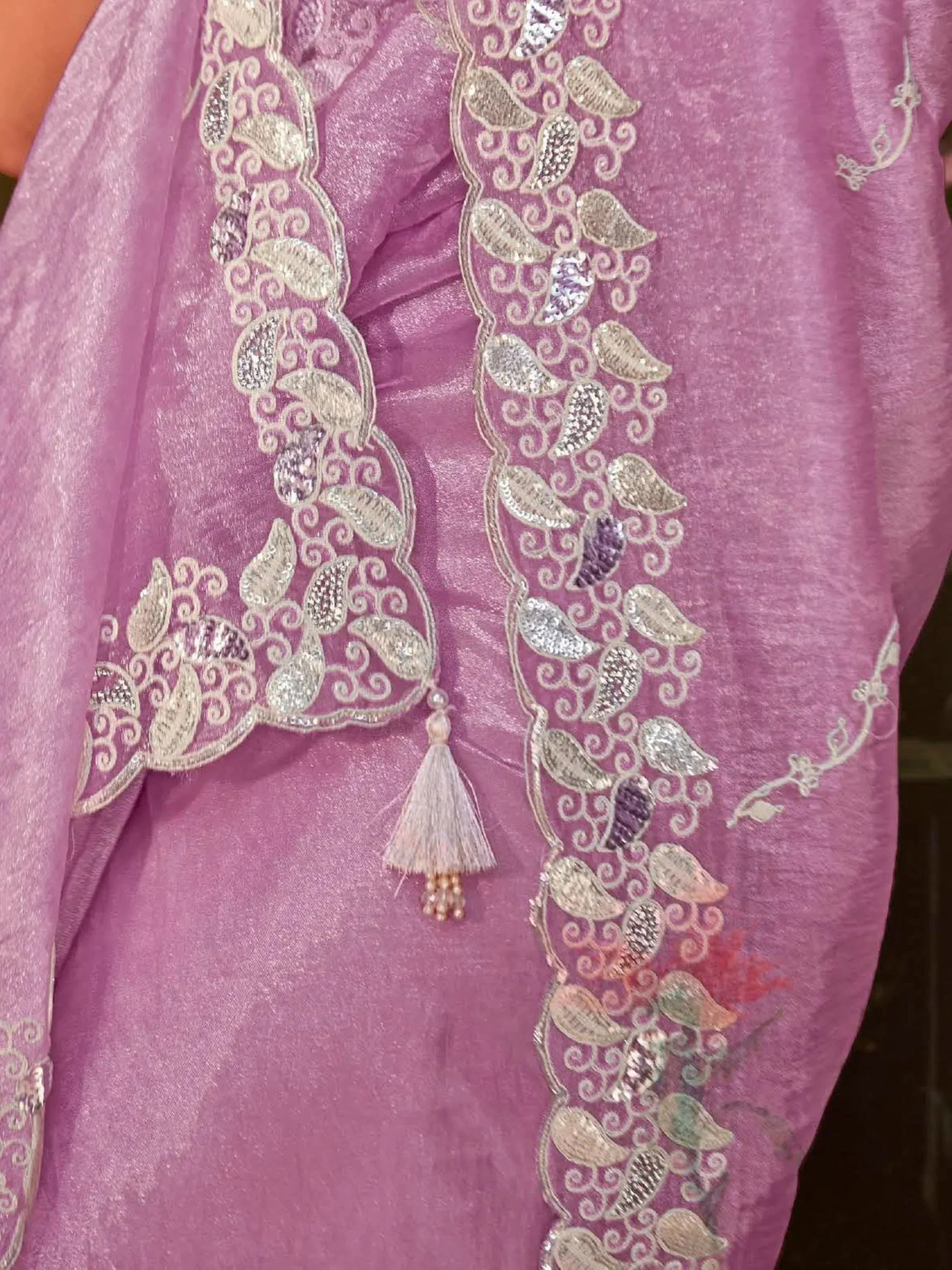 Pink ethnic gown with gold paisley embroidery and tassel detail, perfect for Indian festive wear.