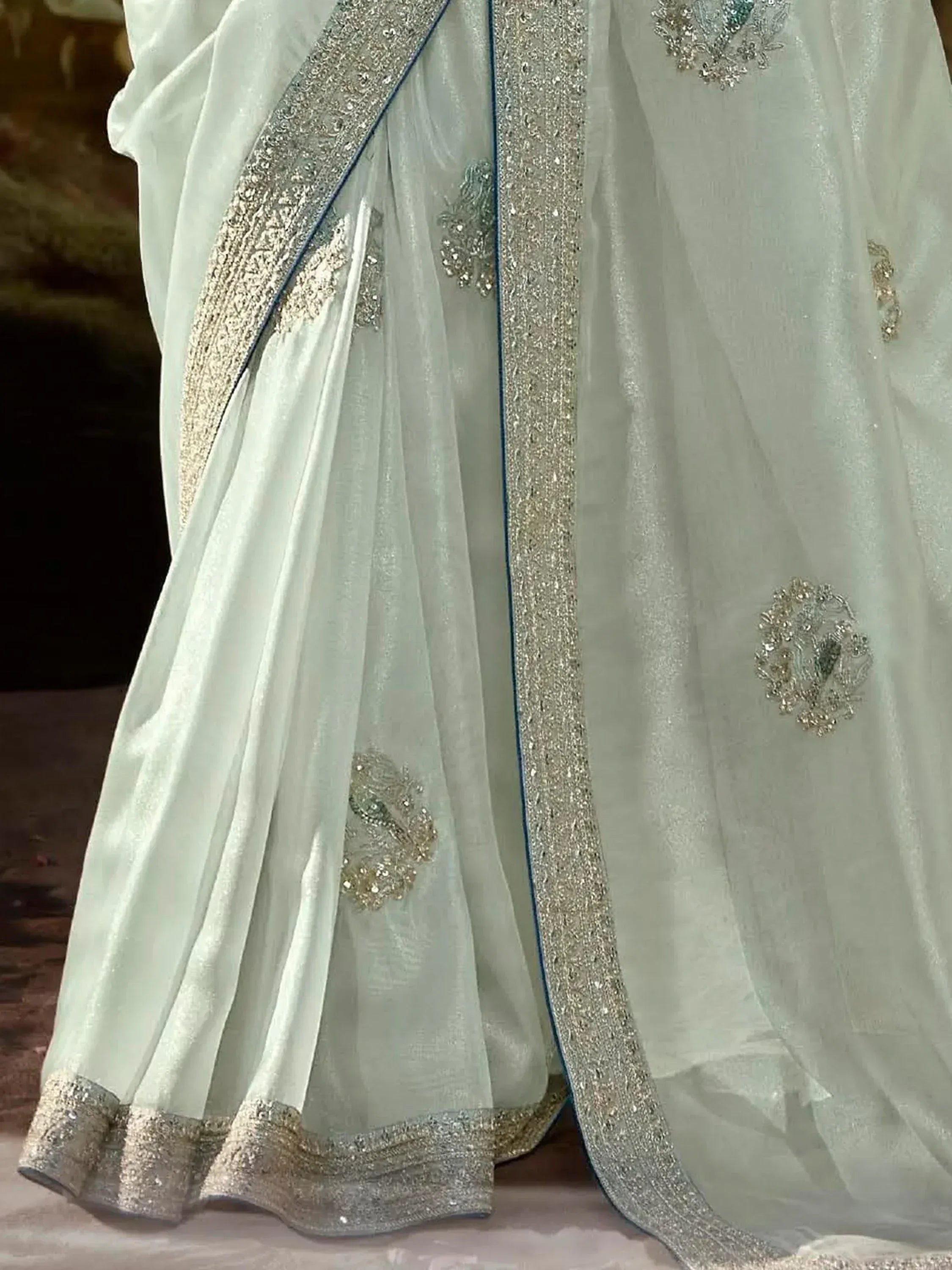 Elegant light green saree with silver embroidery and sequin border, perfect for Indian ethnic occasions