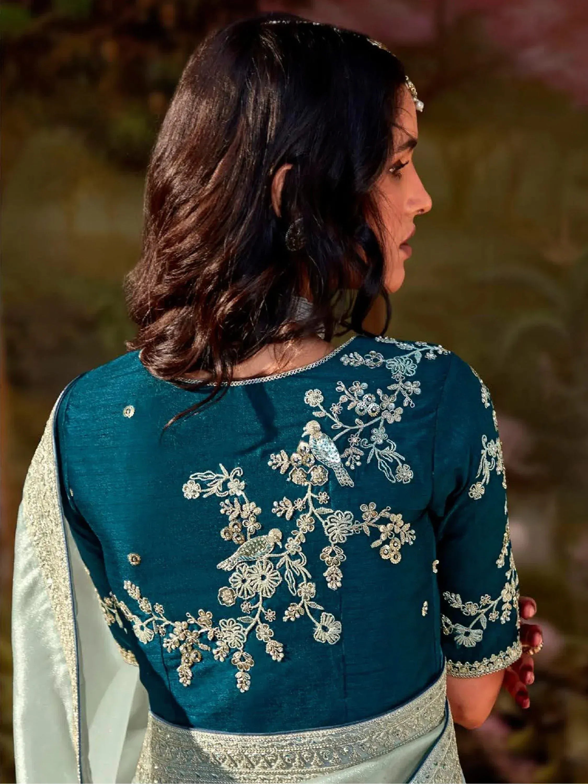 Teal ethnic gown with bird and floral embroidery, perfect for Indian occasions