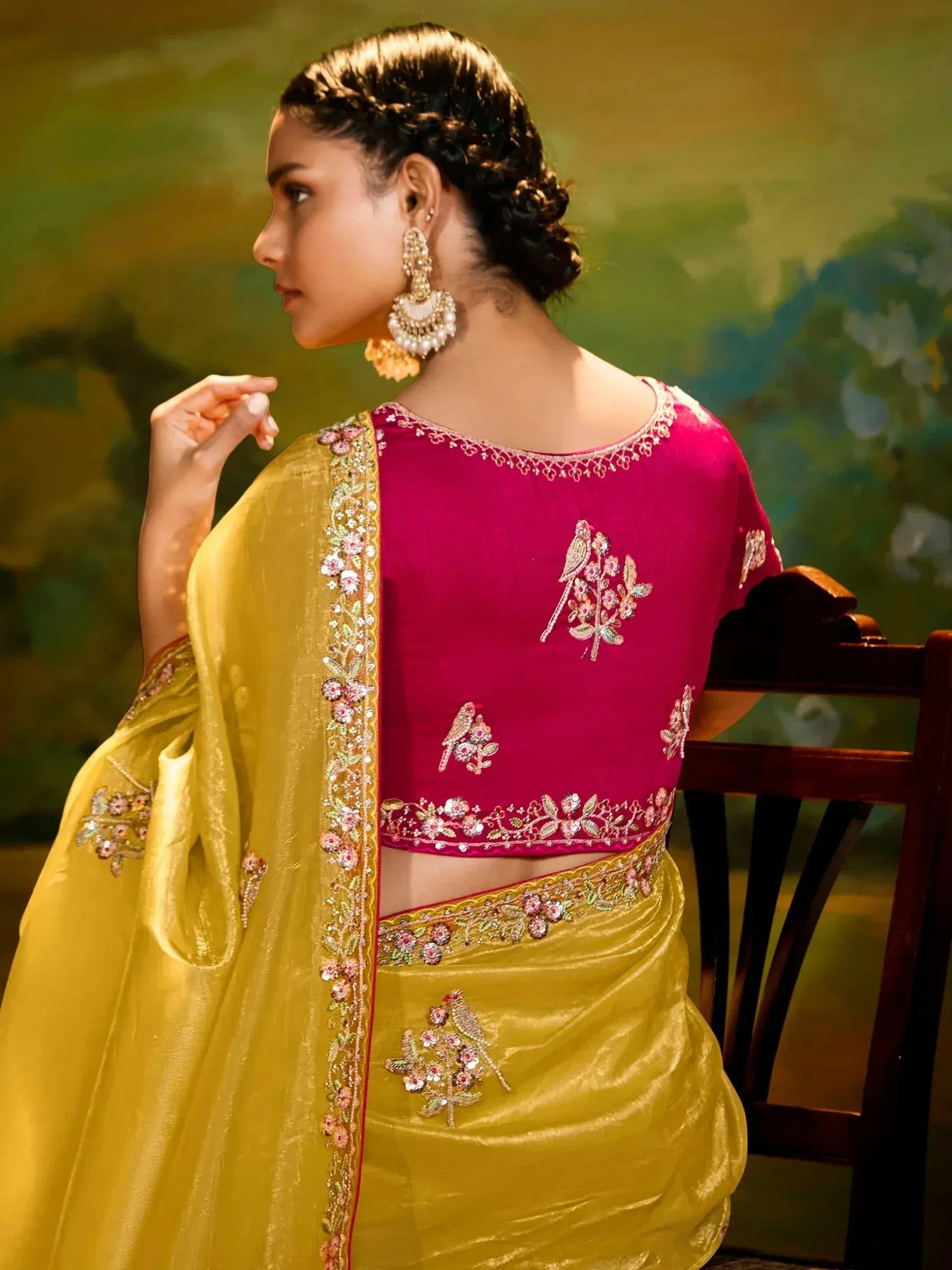 Elegant yellow saree with pink embroidered blouse, floral and bird motifs, perfect for Indian ethnic occasions